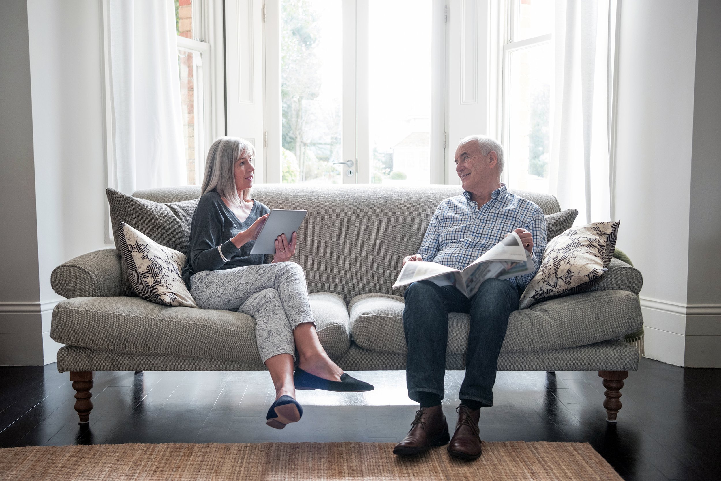 Senior couple having a discussion on the couch