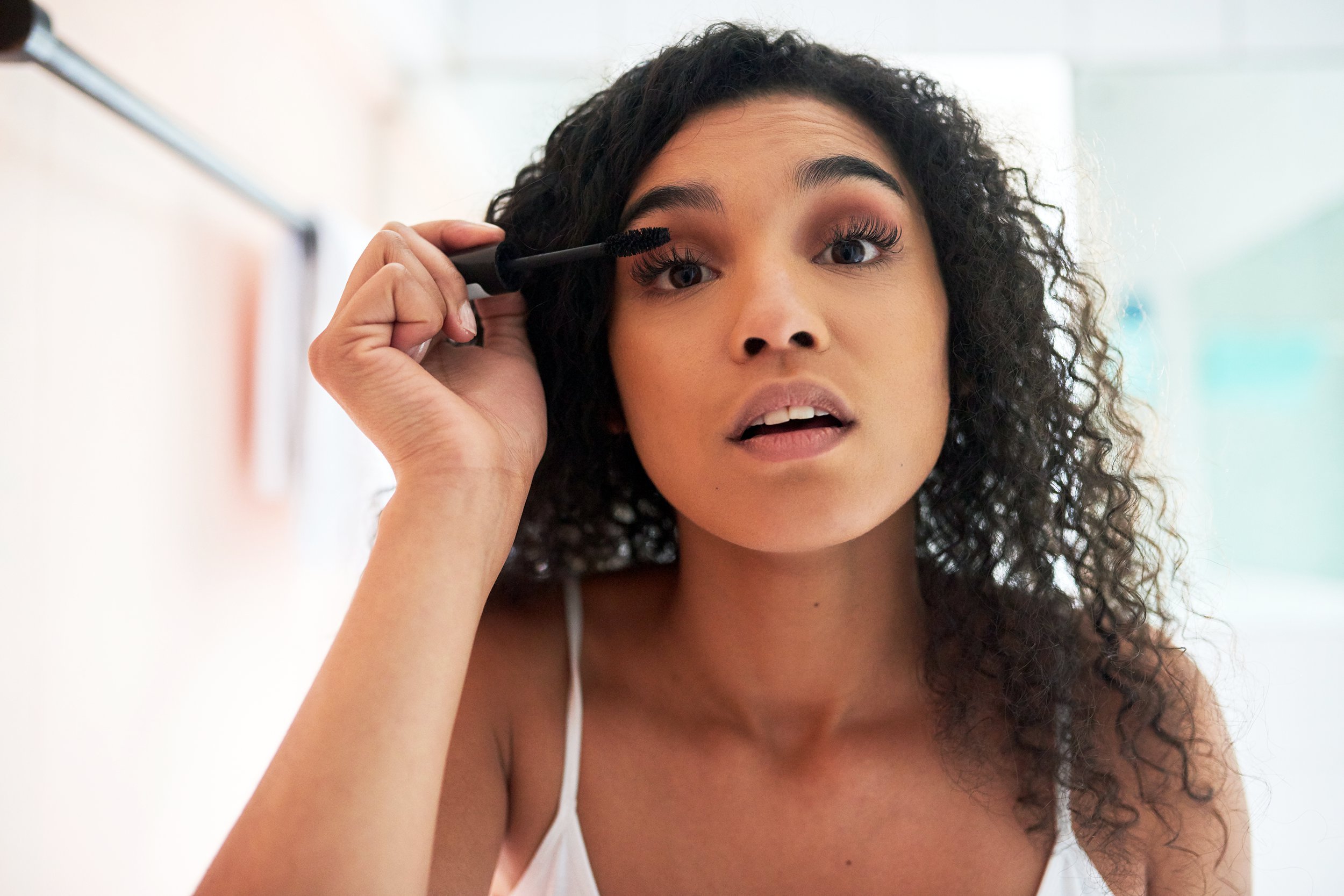 Woman applying mascara