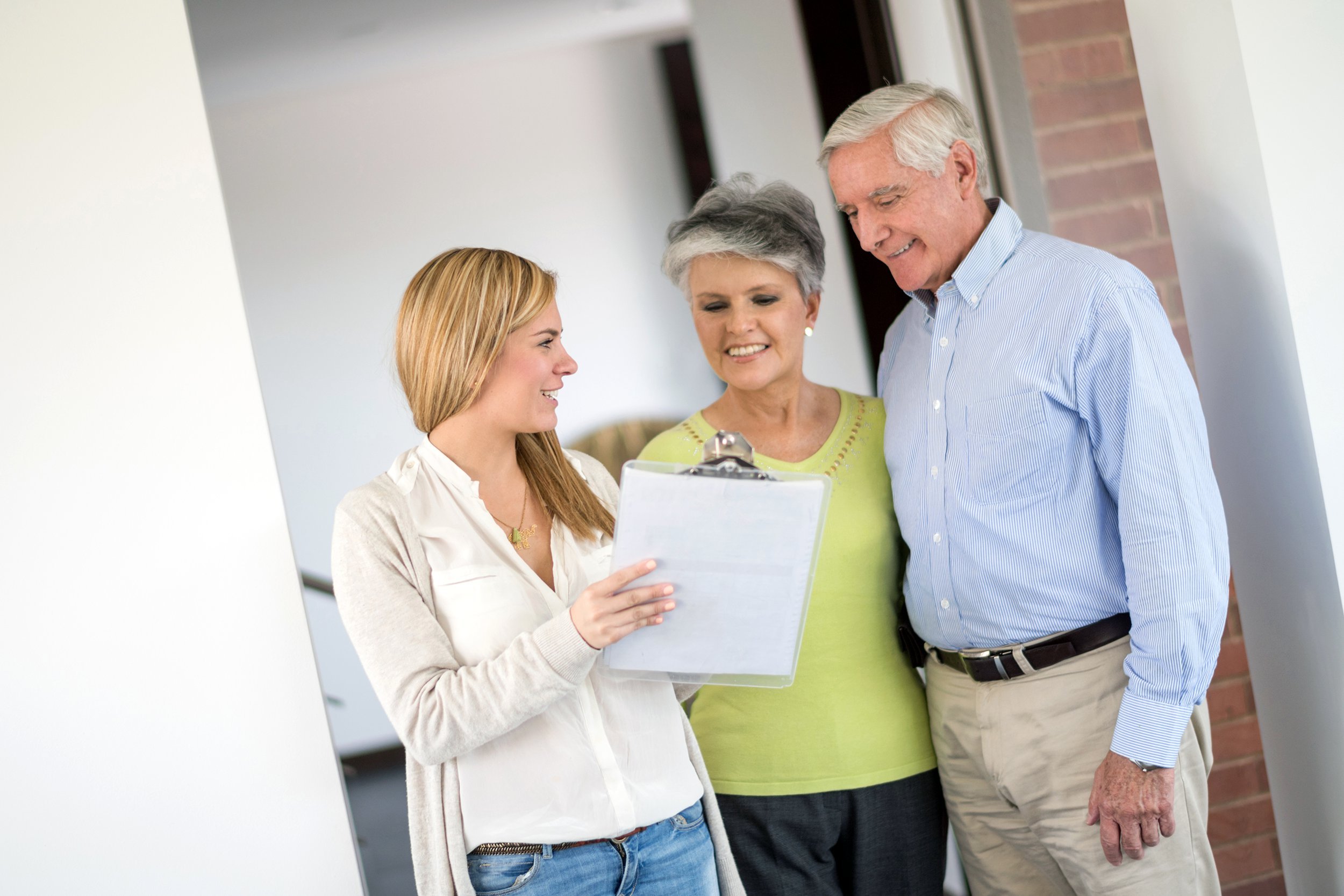 Older couple reviewing rules with a real estate agent