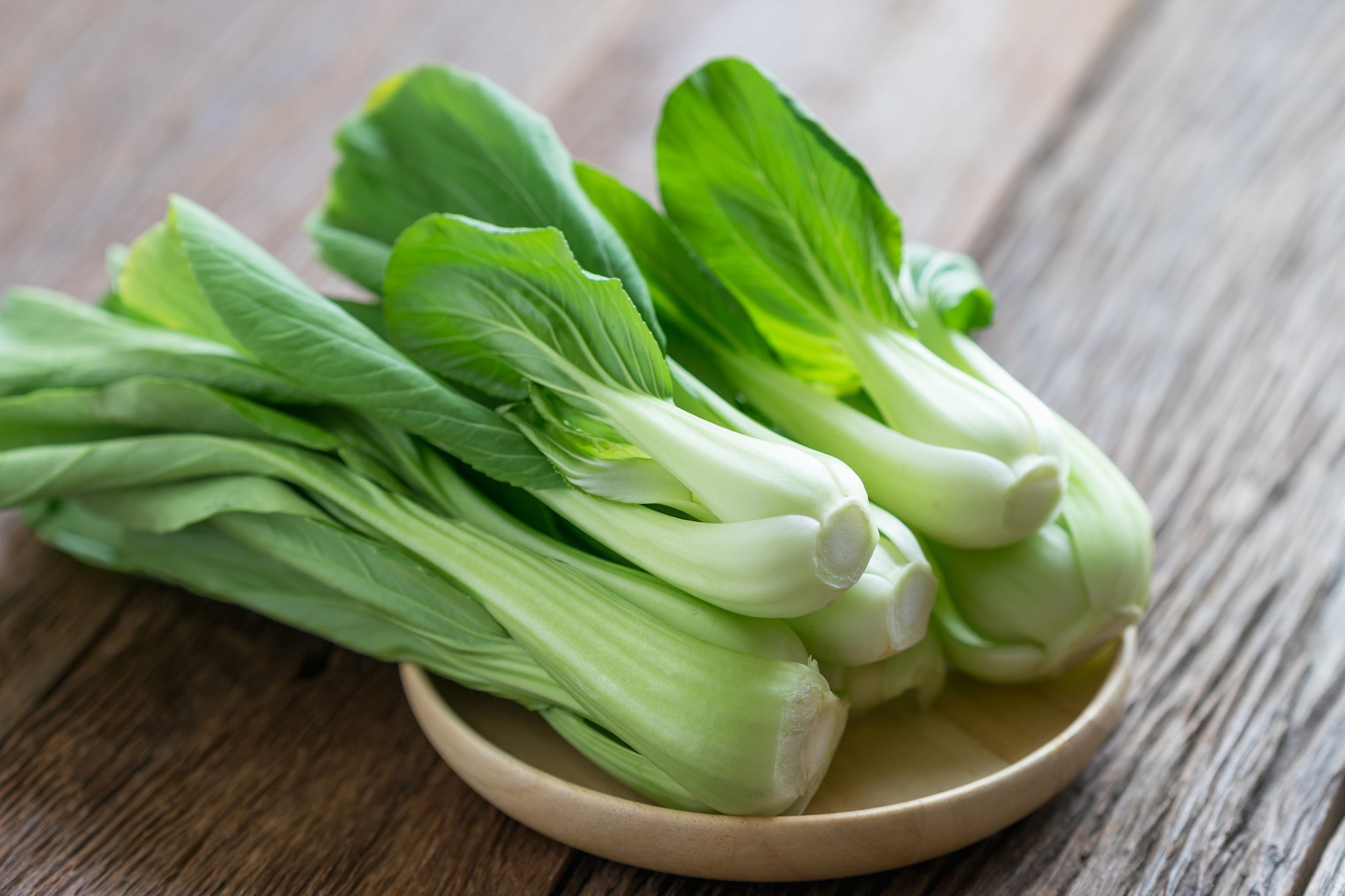 bok choy on wooden table
