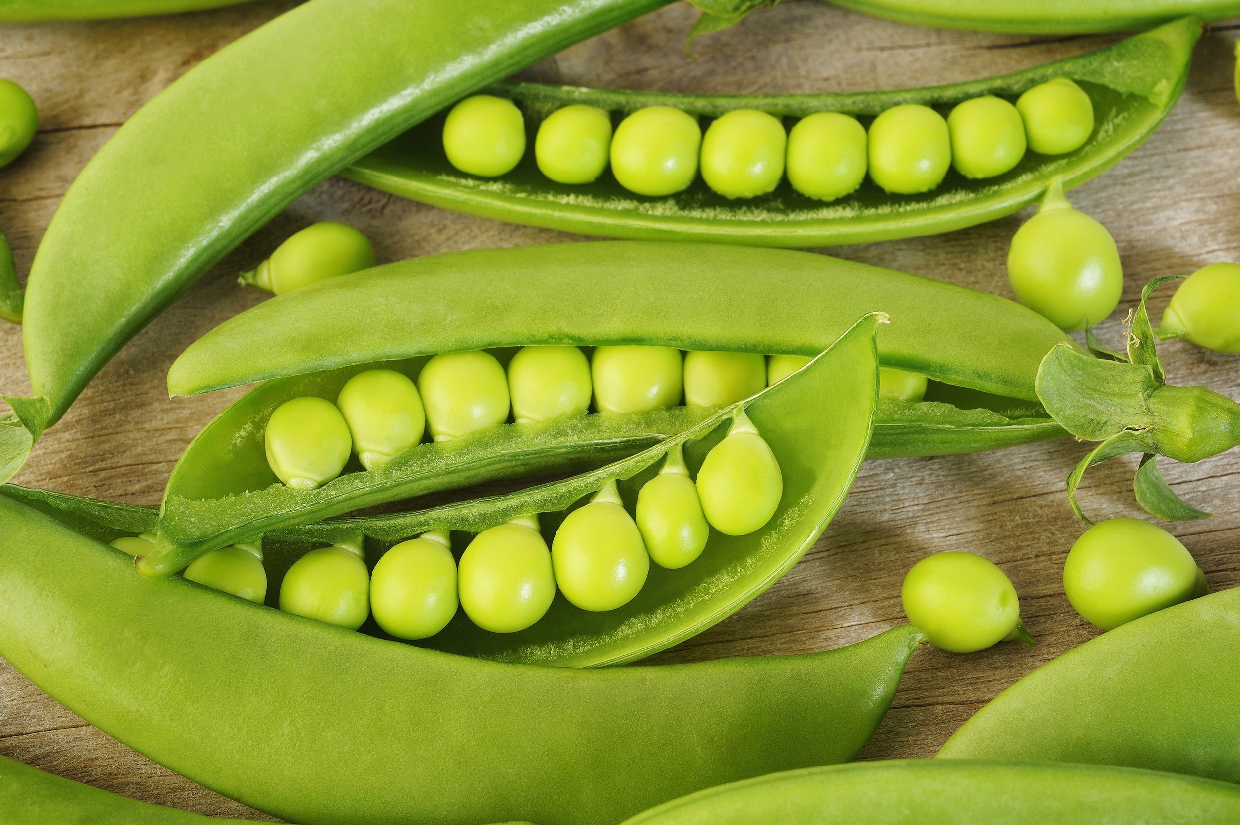 fresh sugar snap peas on wooden background