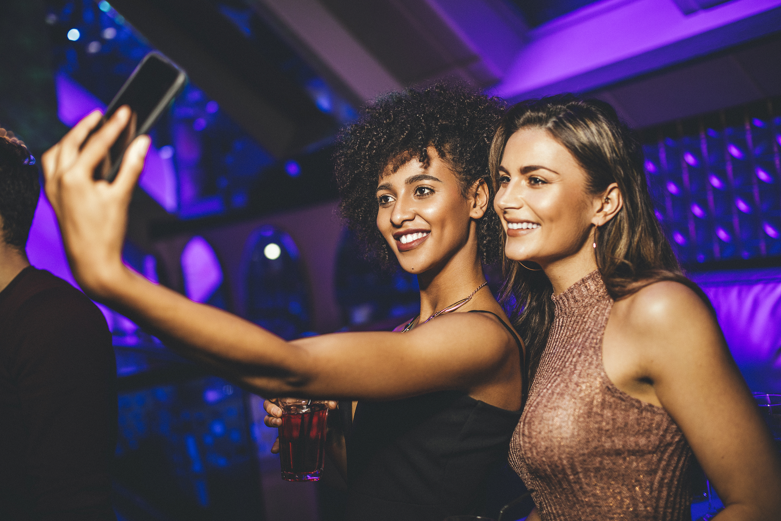 Women at a night club taking a selfie