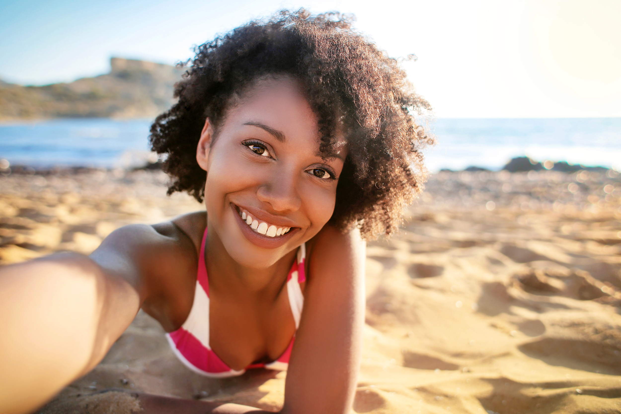Woman taking selfie on the beach