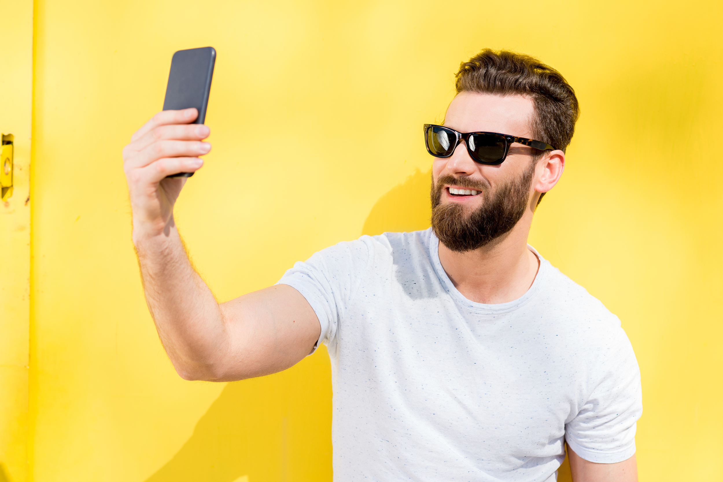 Man taking selfie wearing sunglasses