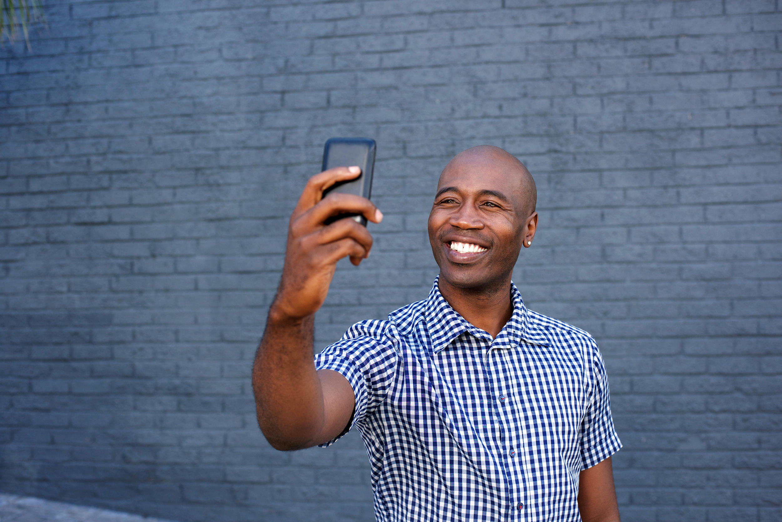 Confident man smiling and taking a selfie