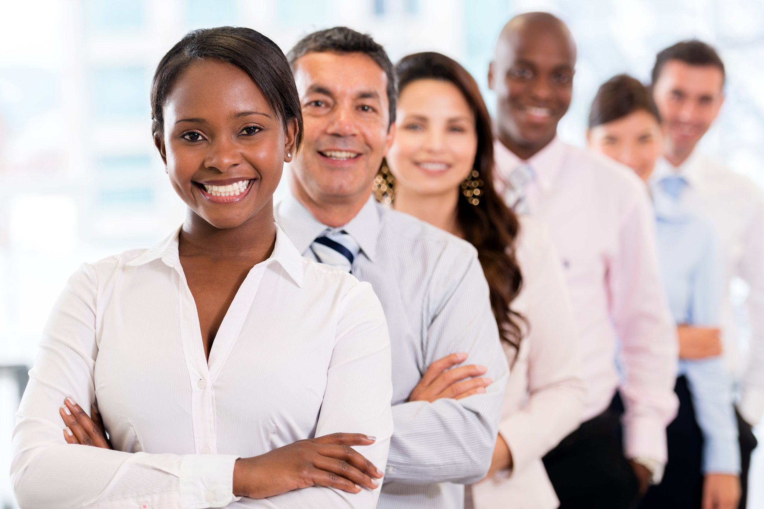 Lineup of happy mixed race workers
