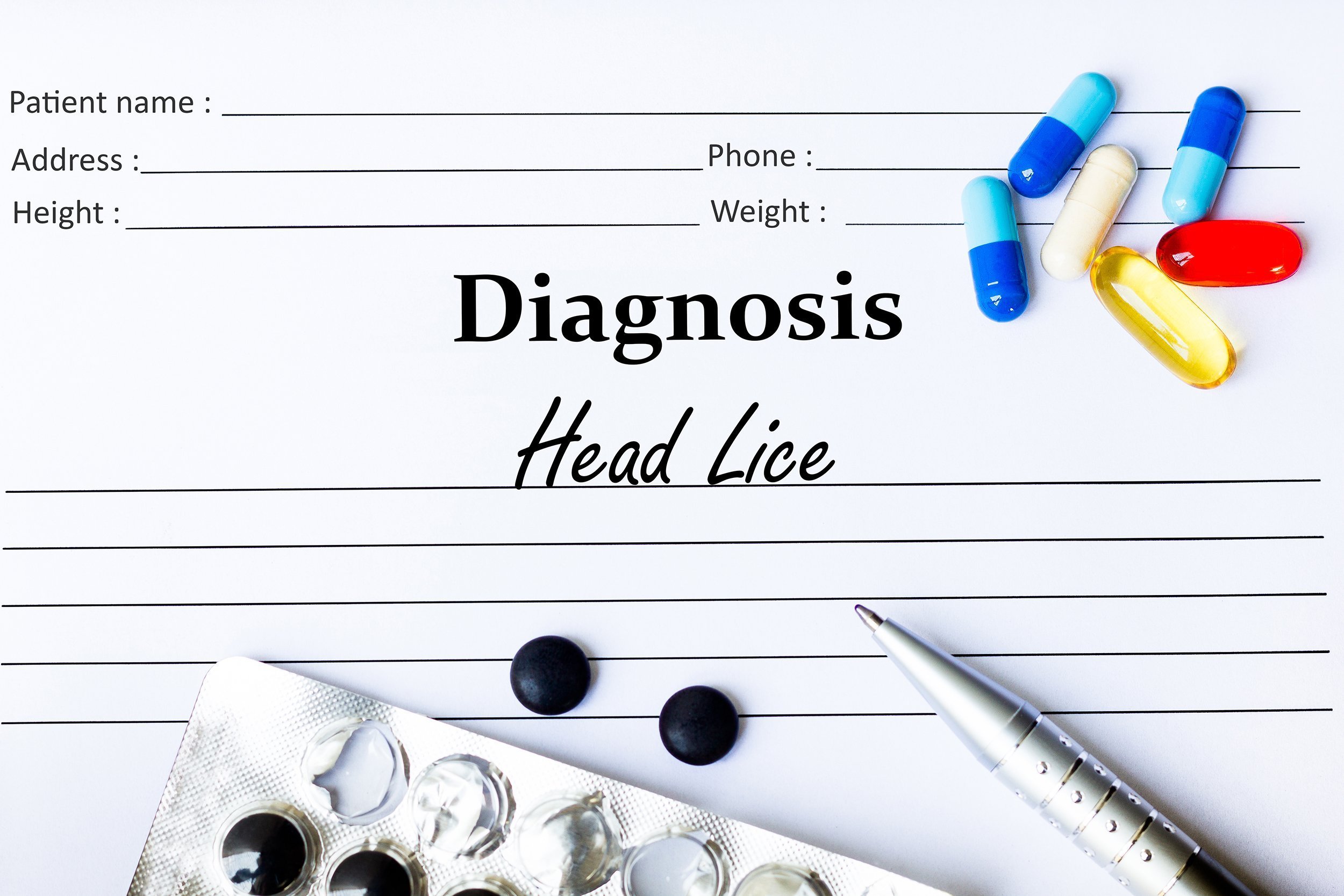 Lice diagnosis written on paper with medication