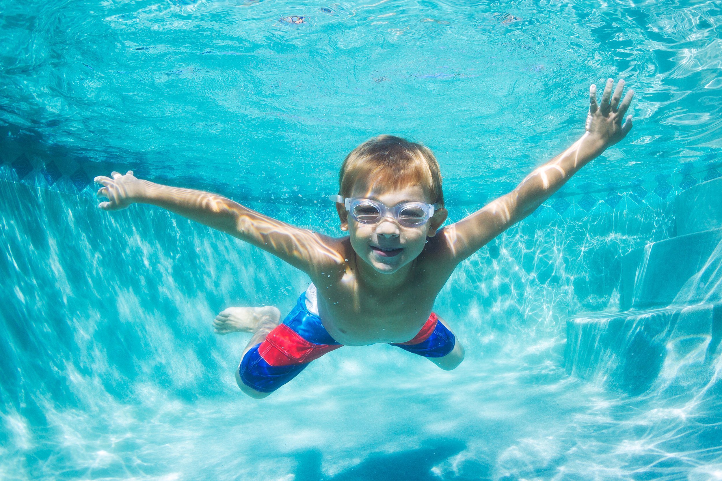 Boy underwater swimming in a pool