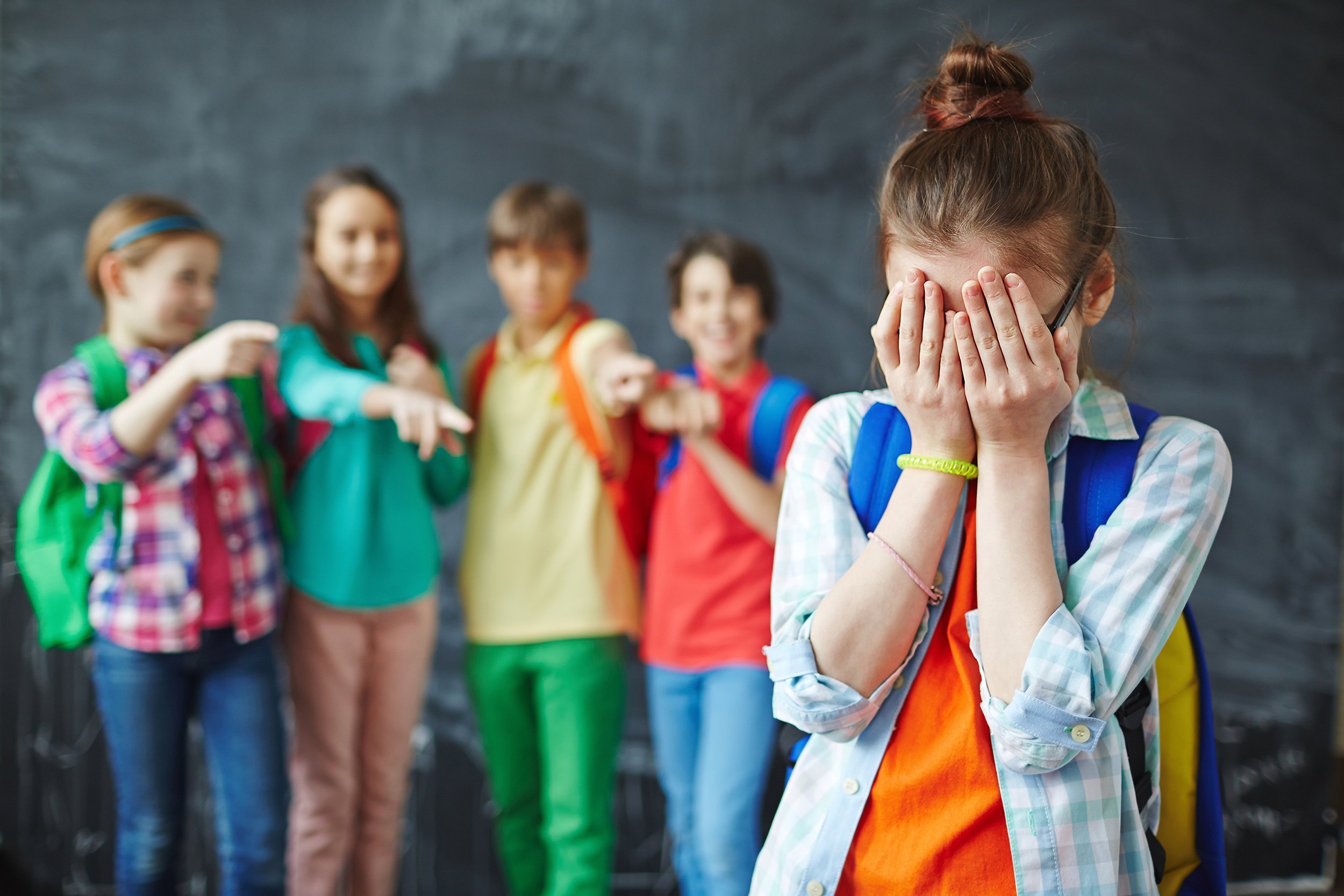 Young girl being ostracized by her classmates