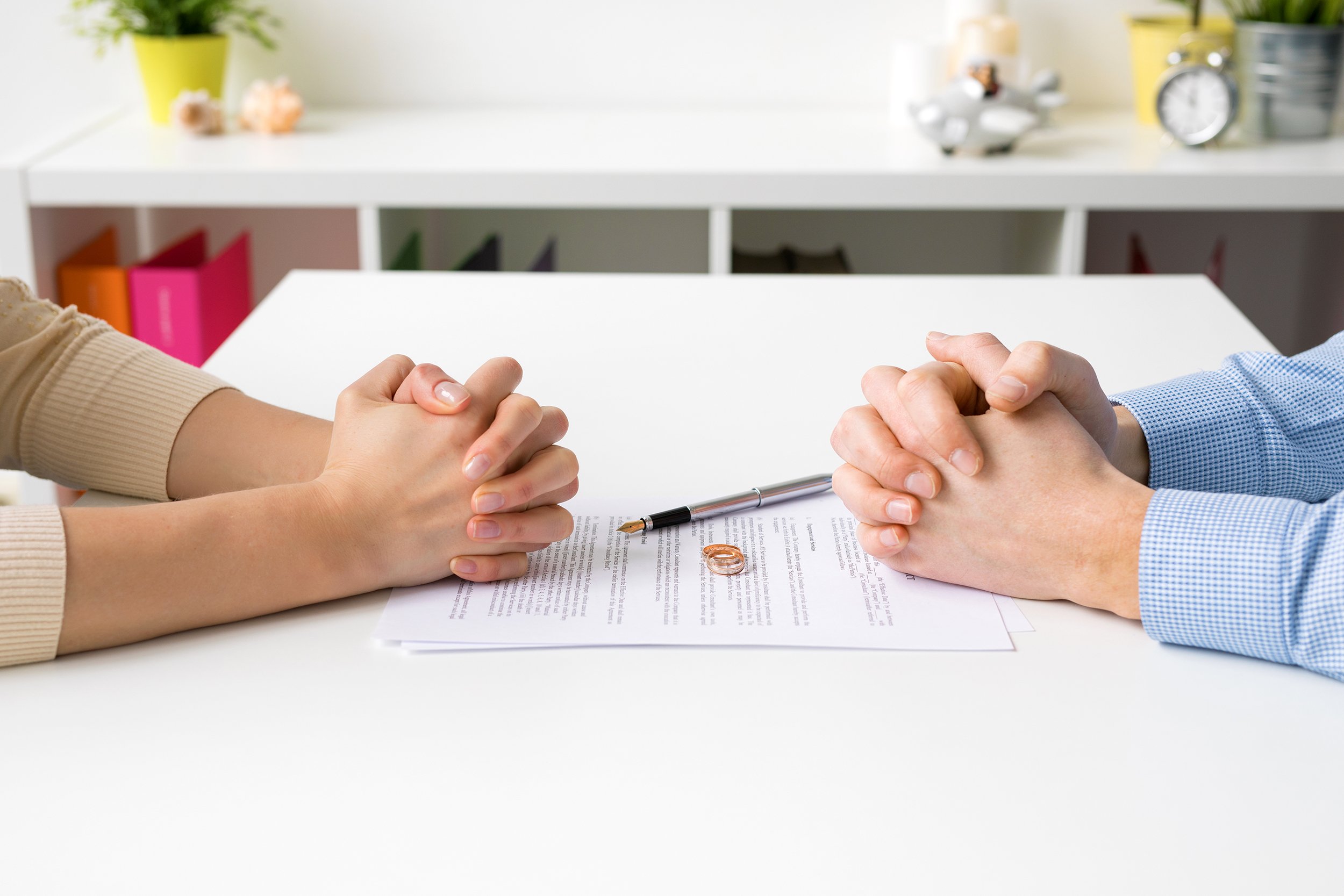 Couple going through divorce discussing papers at a table