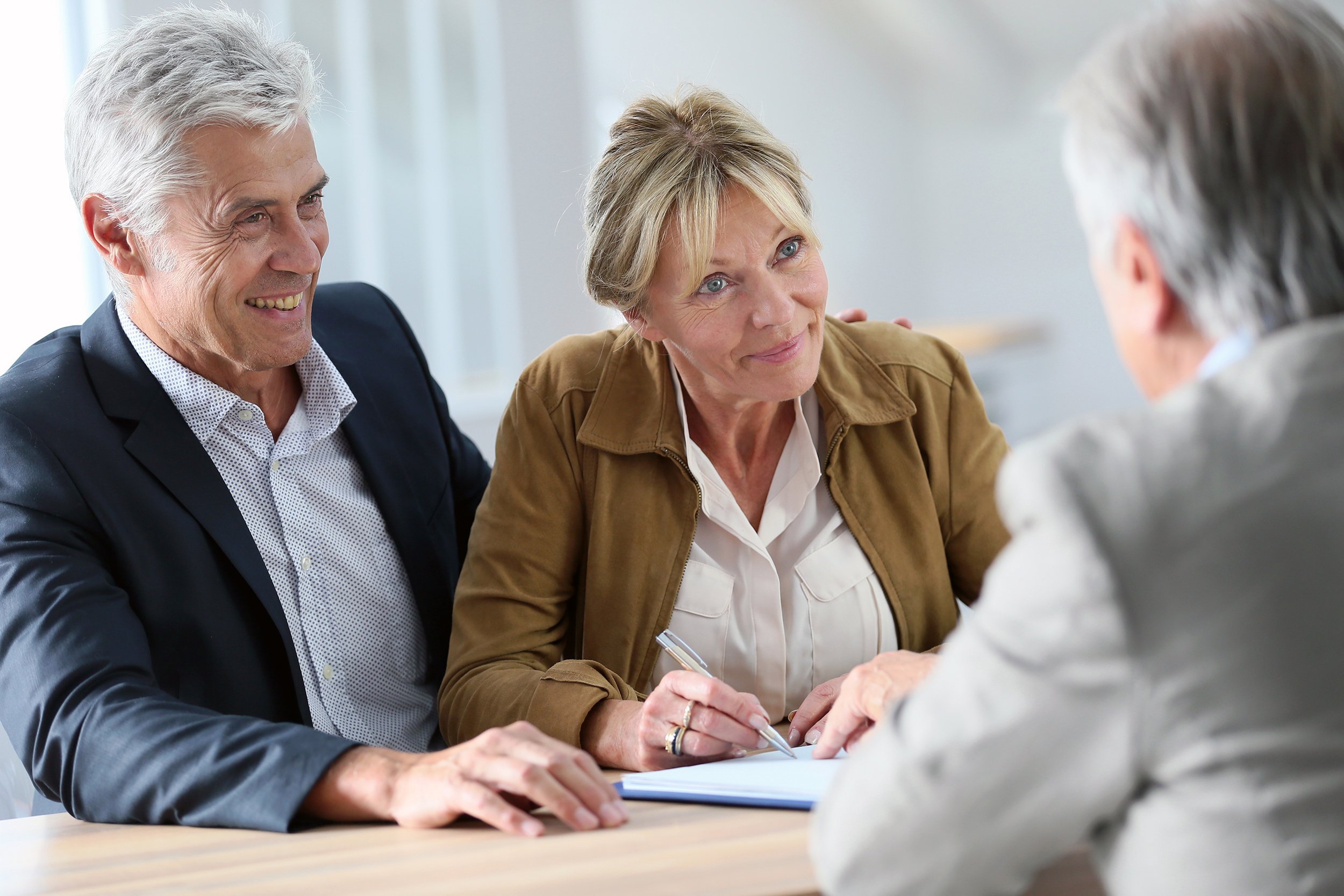 Older couple discussing with a financial planner