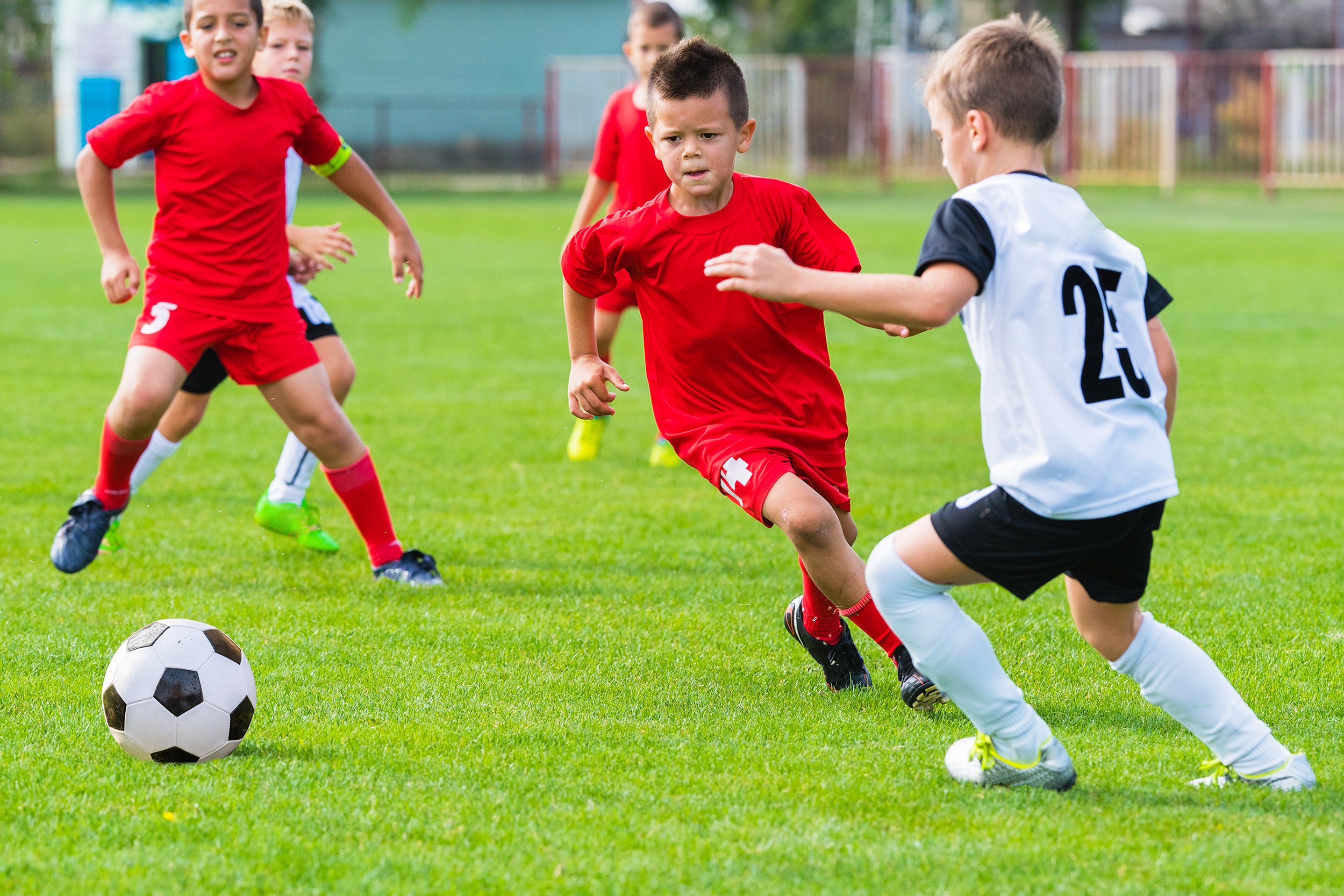 group of kids playing soccer