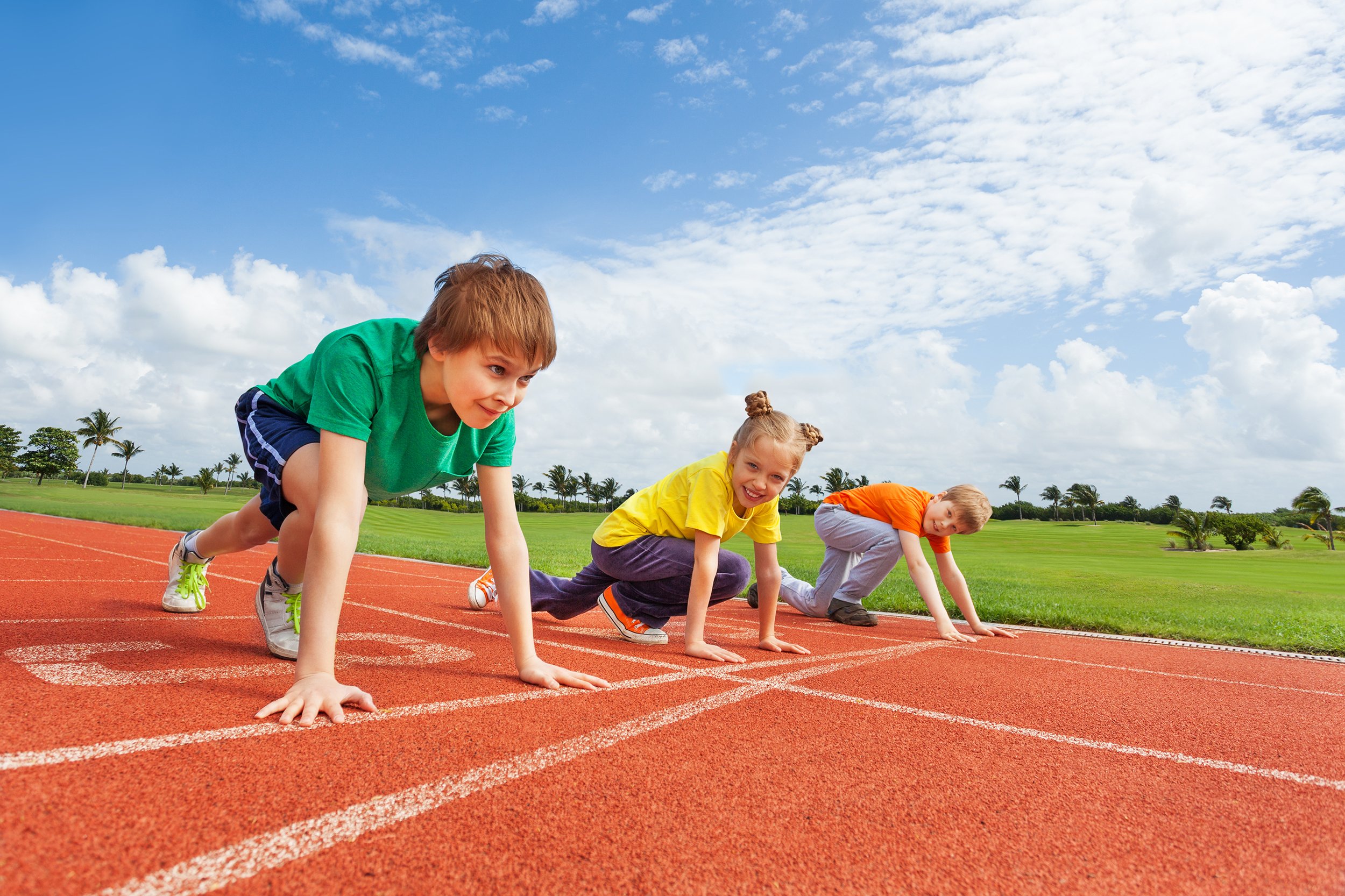 three kids getting ready to run track