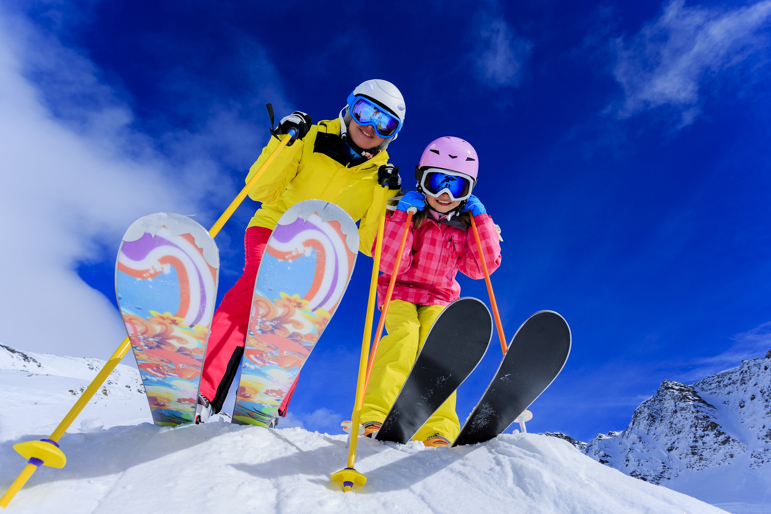 two kid skiers on top of mountain
