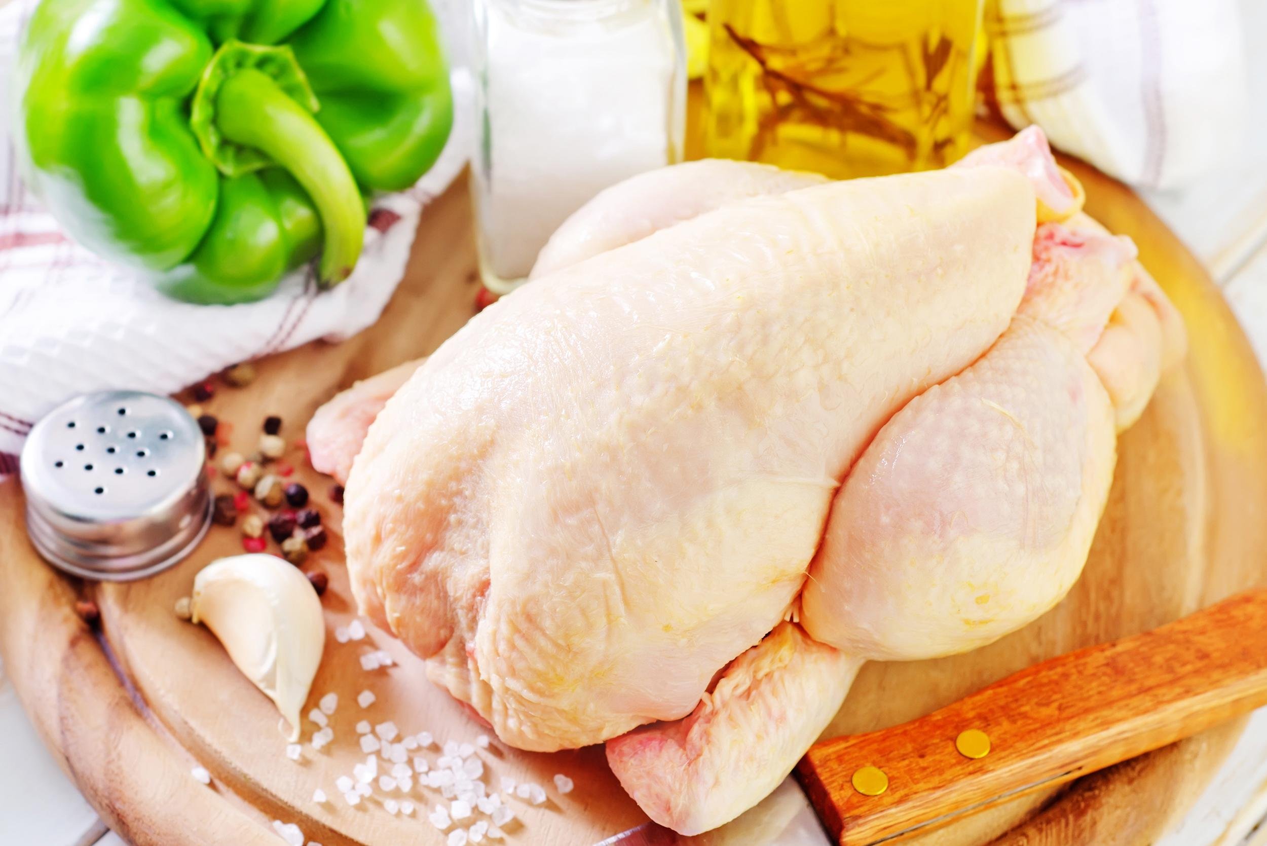 whole chicken on cutting board with ingredients