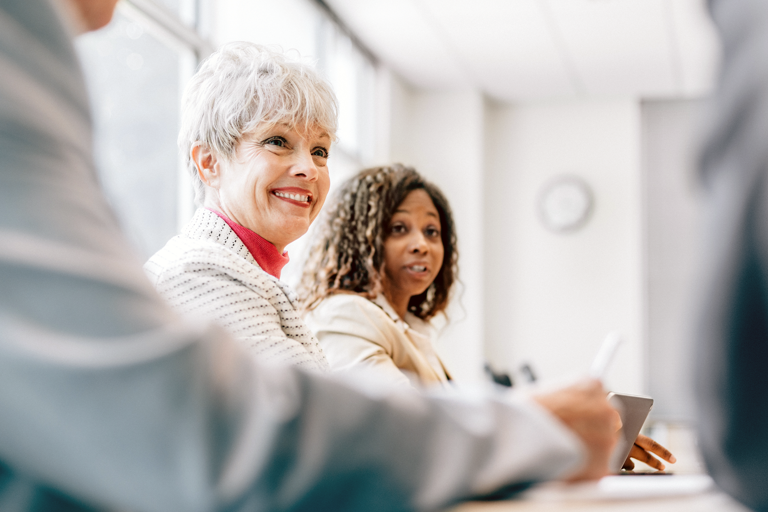Happy senior woman in a business meeting
