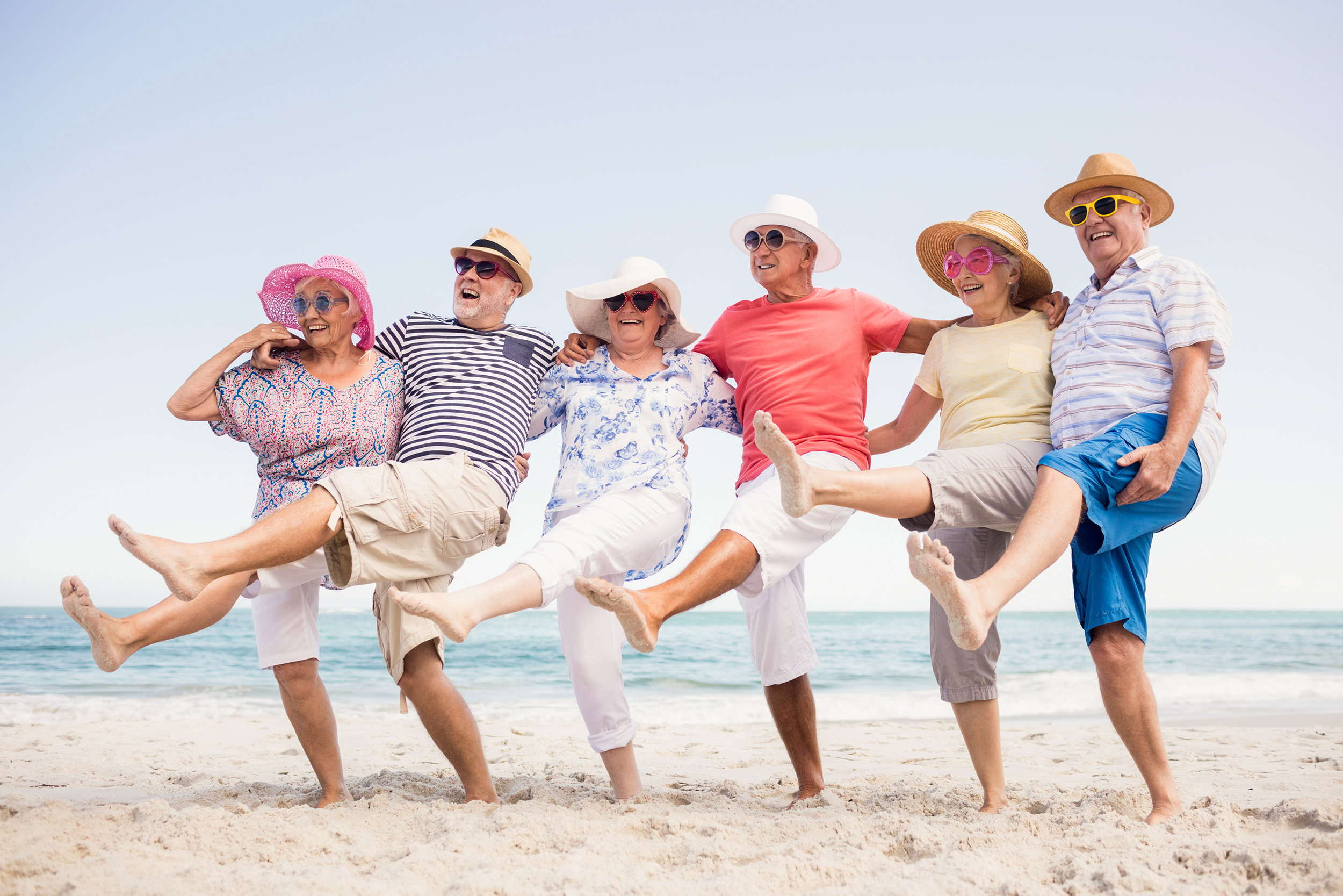 Senior friends acting silly on the beach