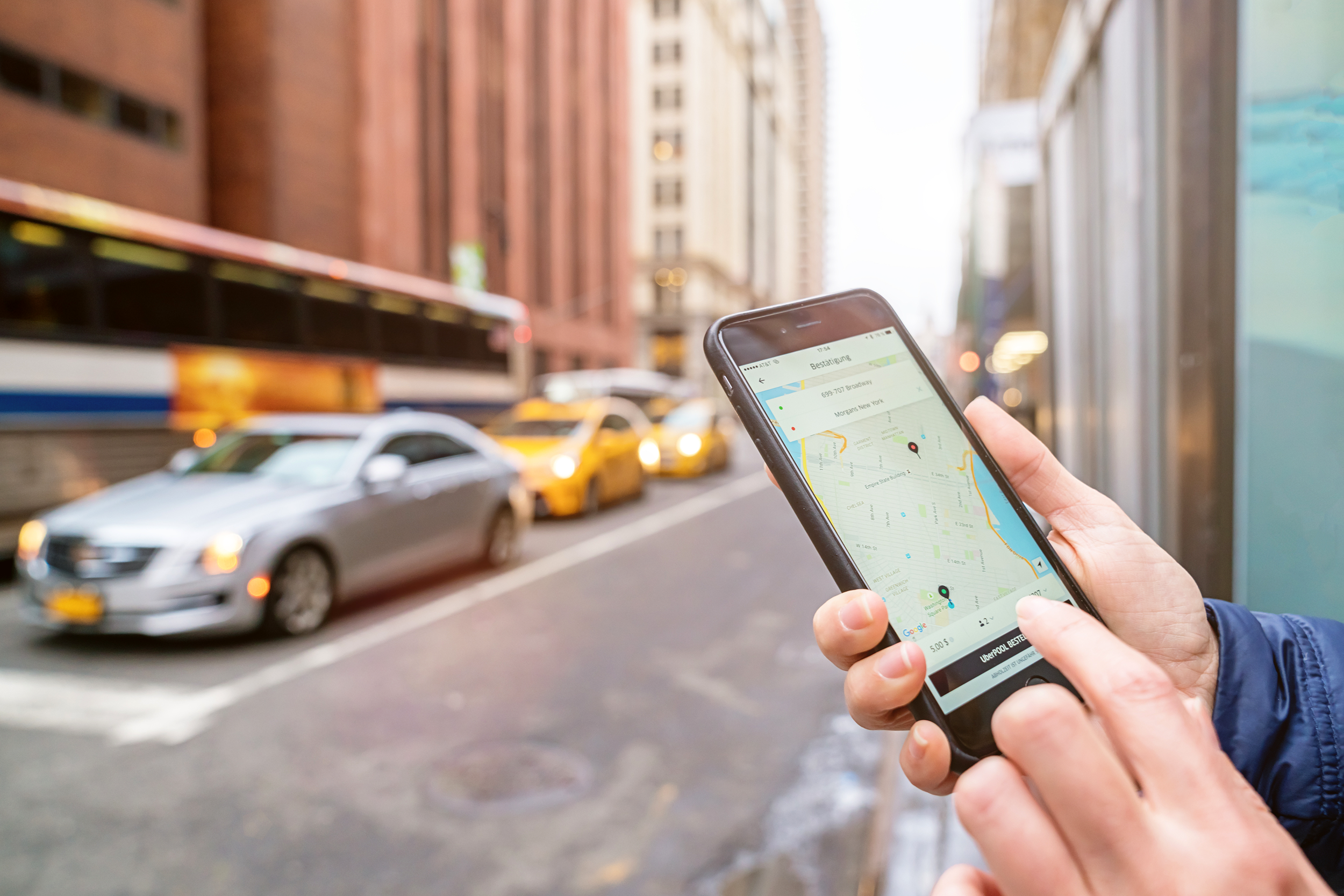Man using ride sharing app on the side of the street