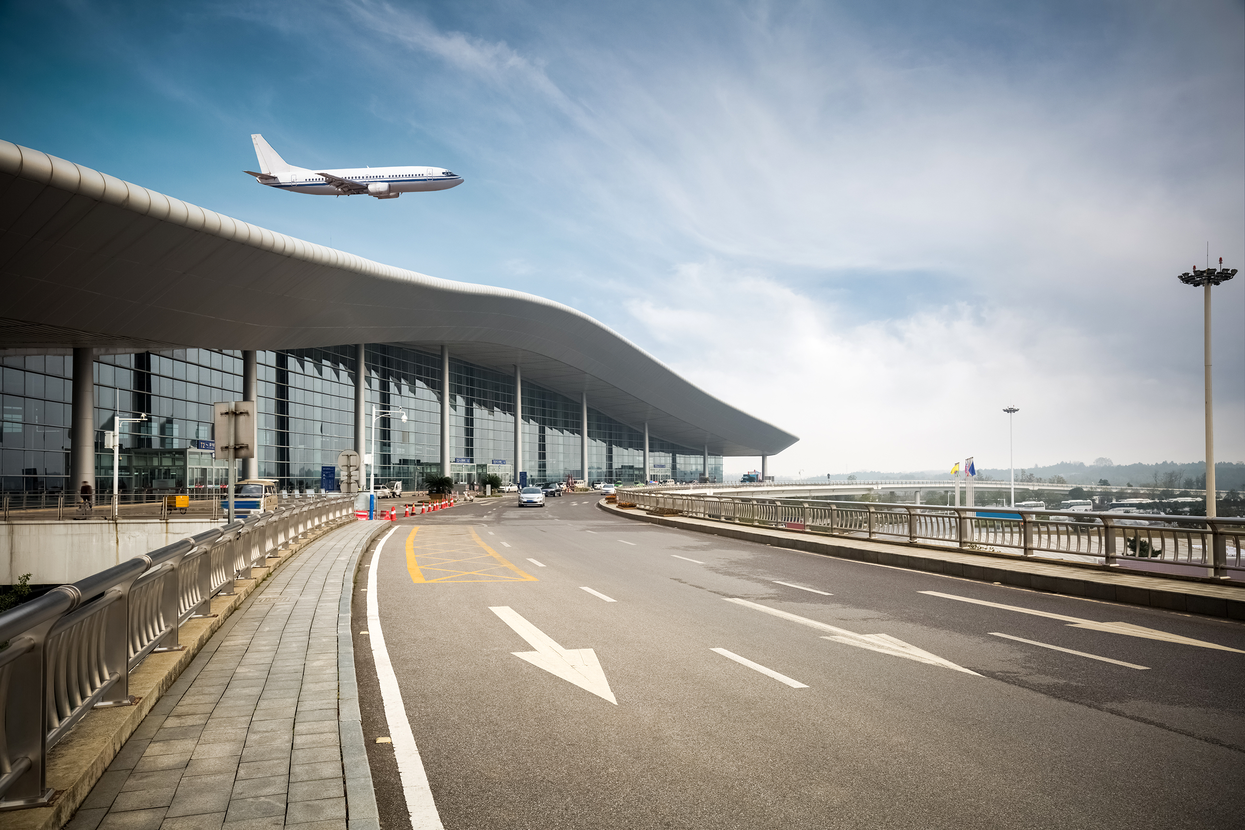 Exterior of an airport with an airplane taking off