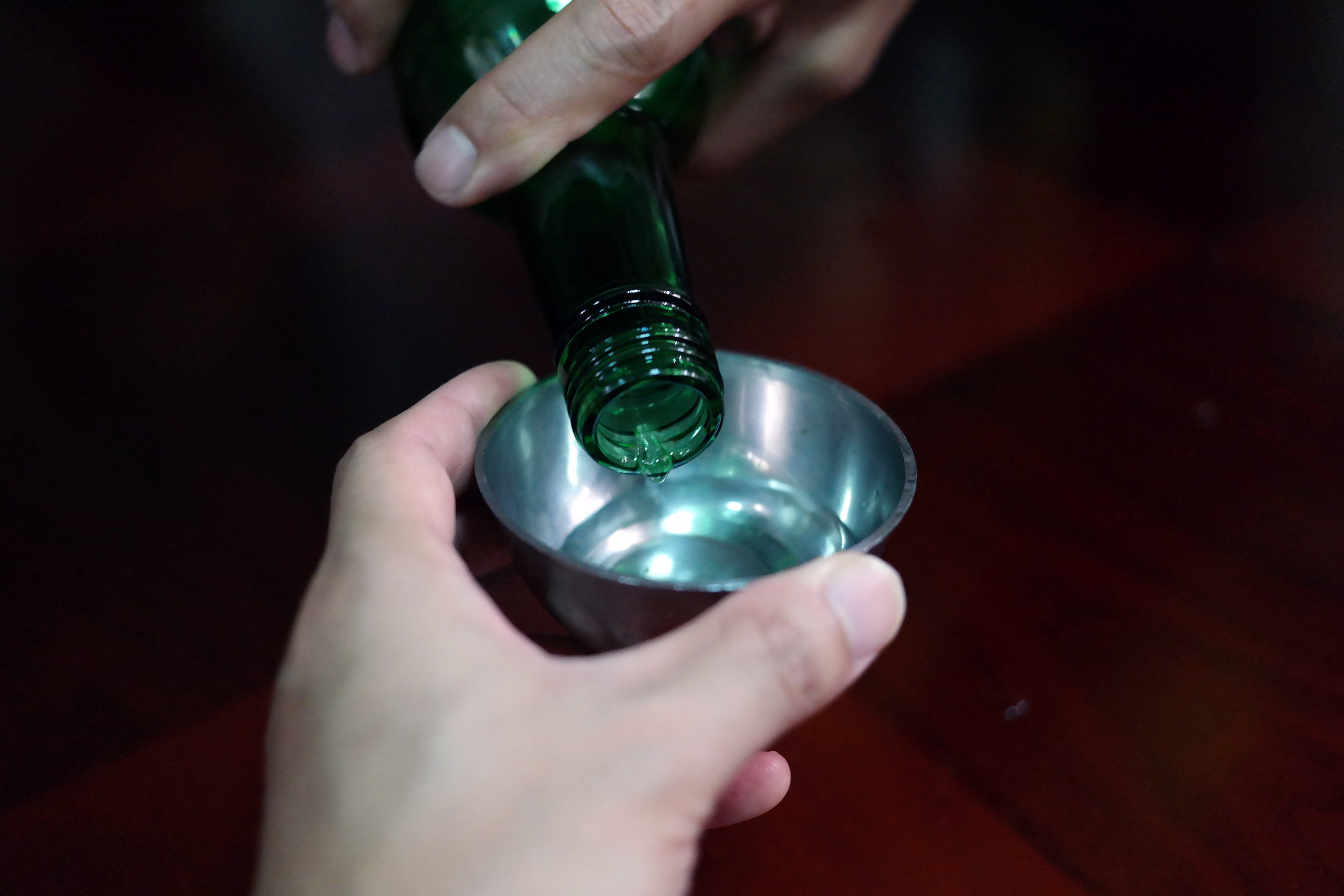 soju being pouring by someone else