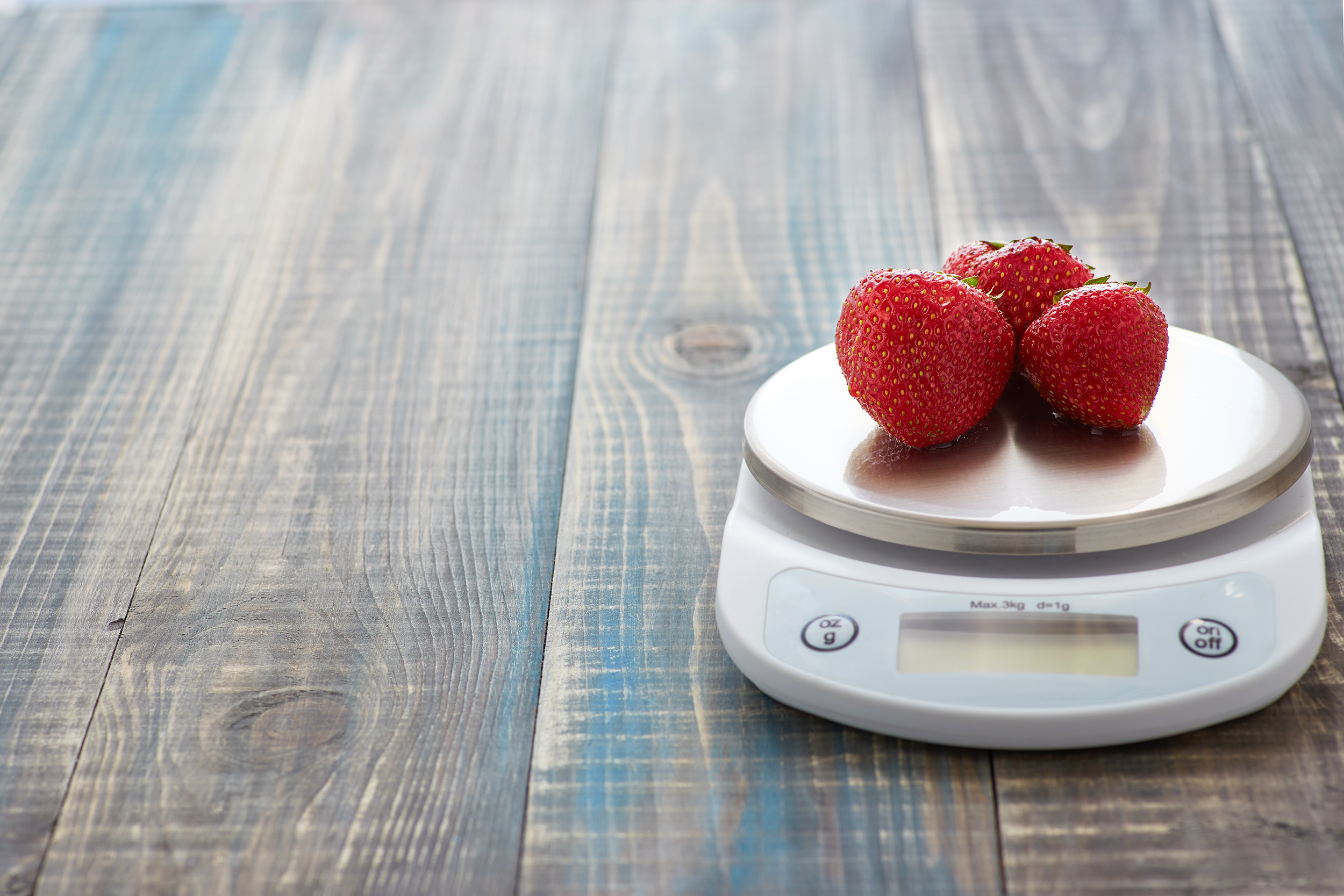 Weighing strawberries on a food scale