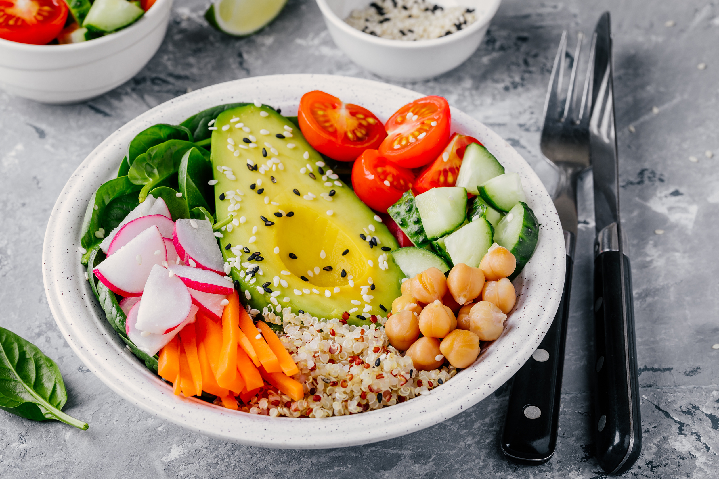 Vegan bowl of quinoa, chickpeas, avocado, and vegetables