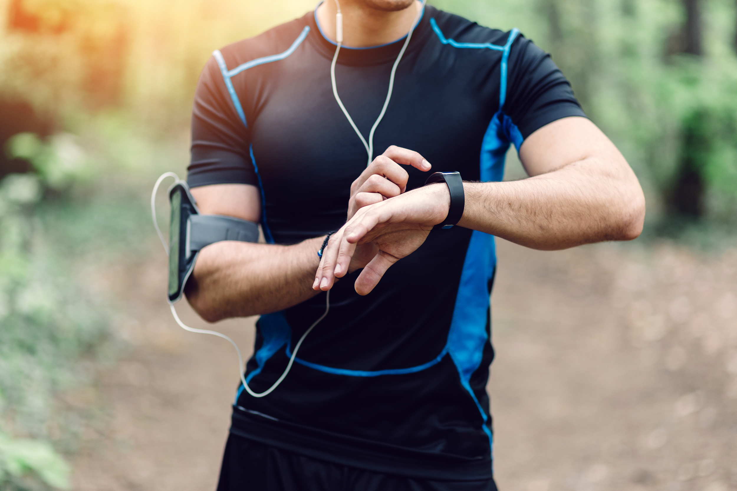 Man setting his watch timer to exercise