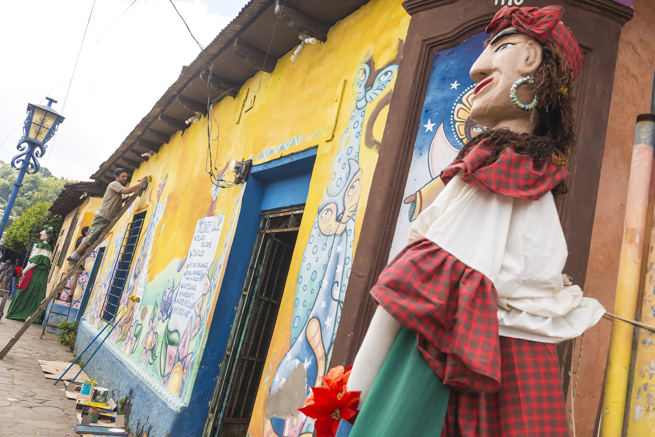 two men painting traditional murals in Ataco, El Salvador