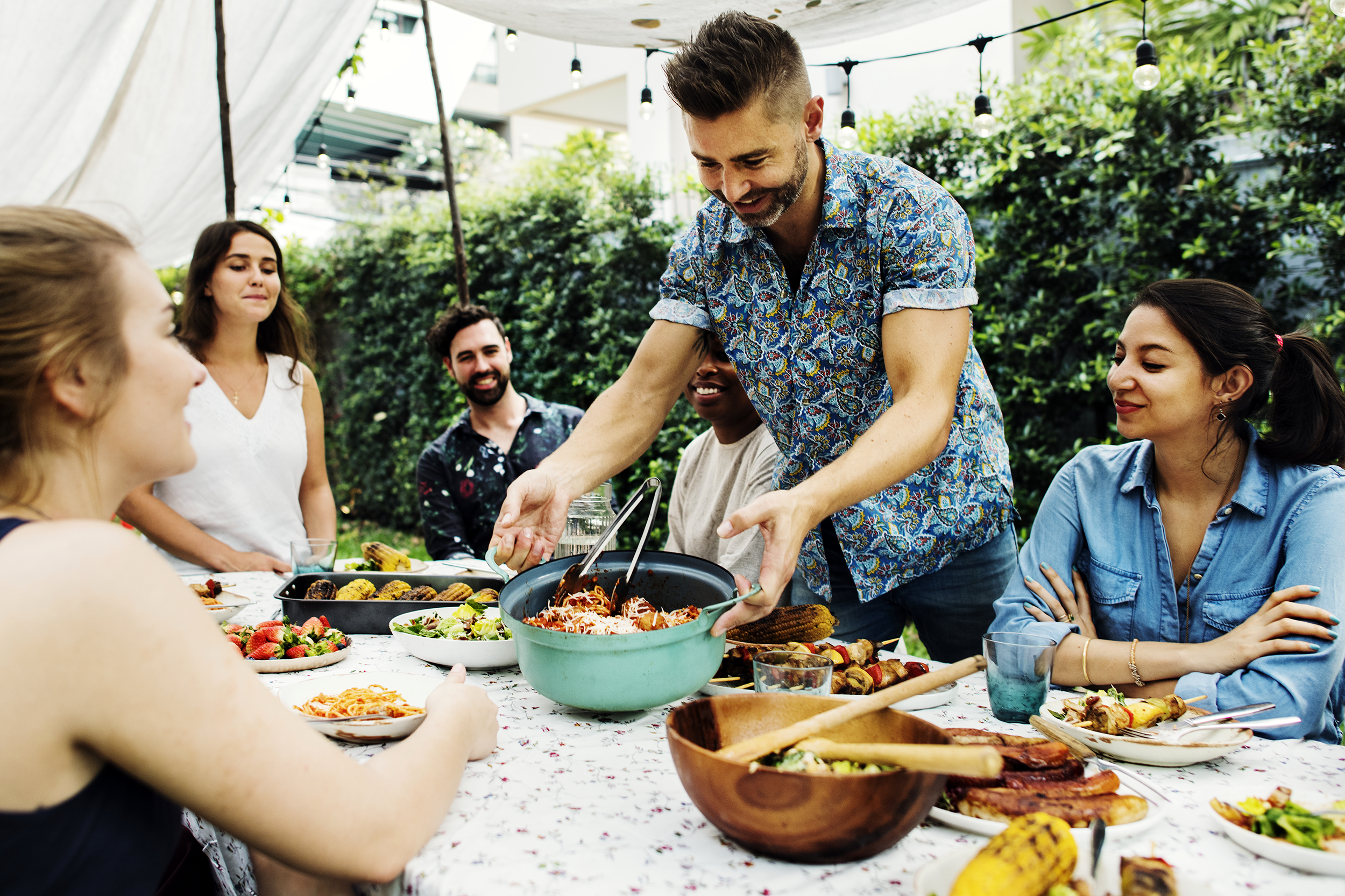 Friends eating outside at a potluck