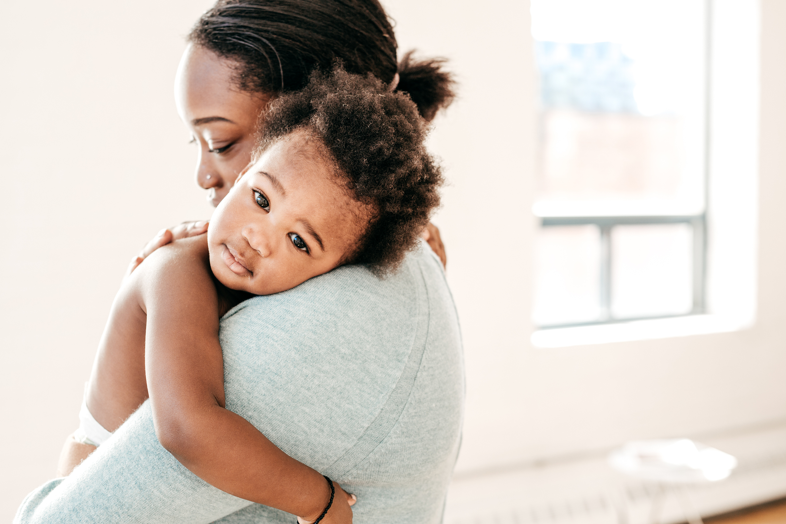 Mother holding her baby looking at the camera
