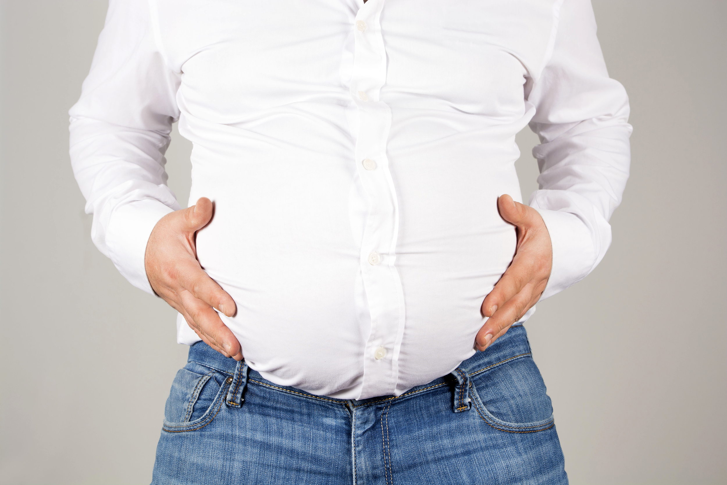 Overweight man holding his belly