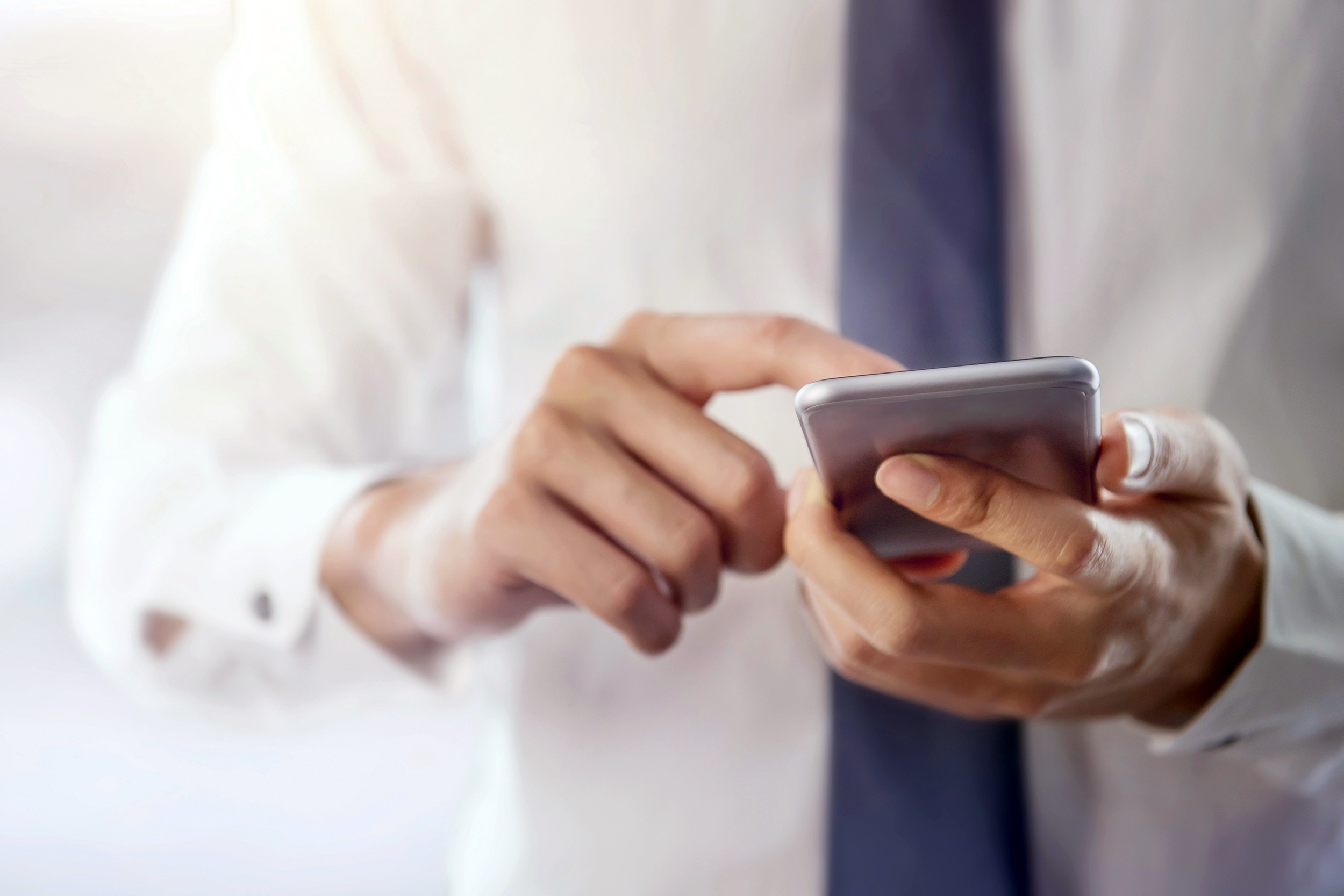 Man scrolling on his smartphone