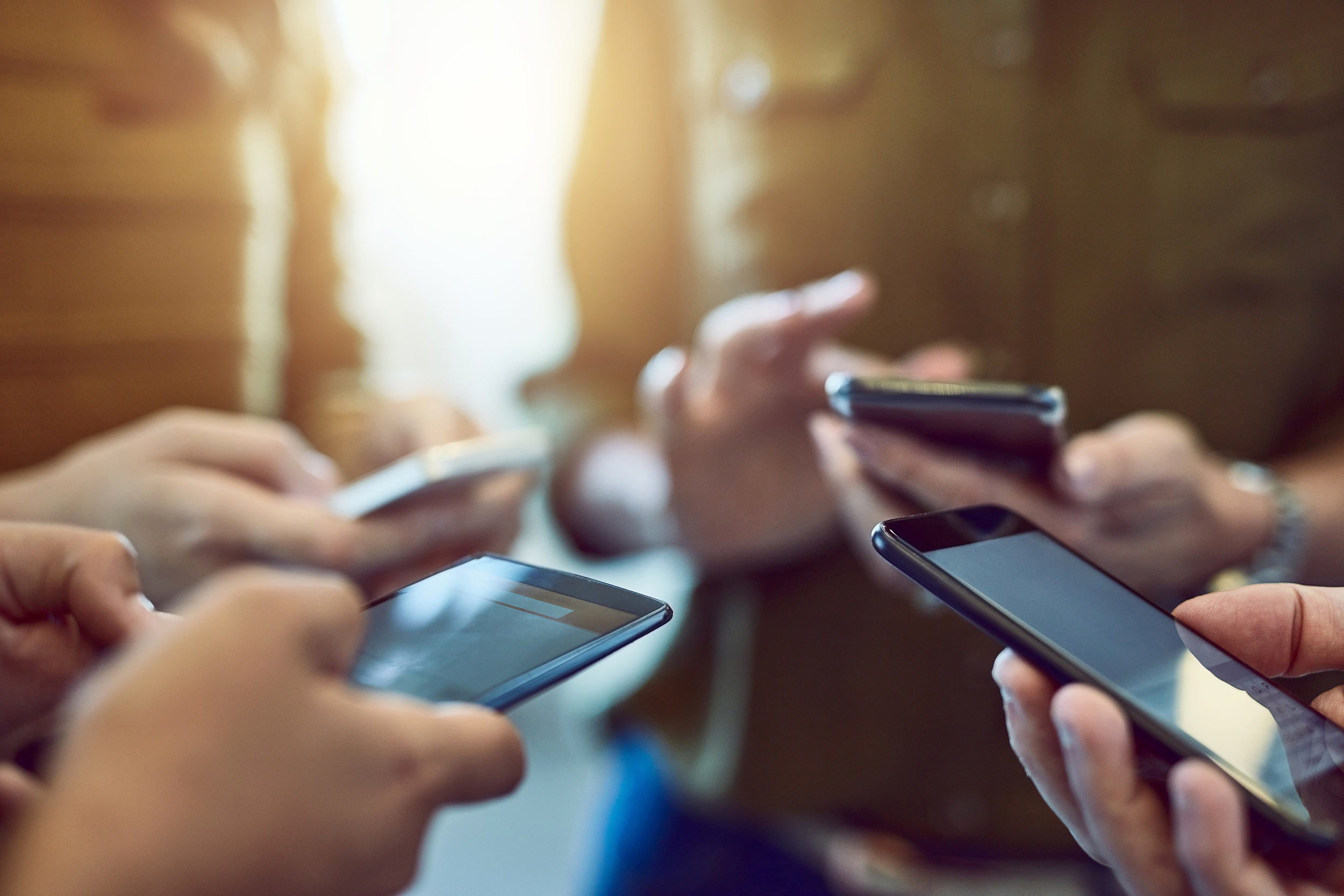 Group of people using their smartphones