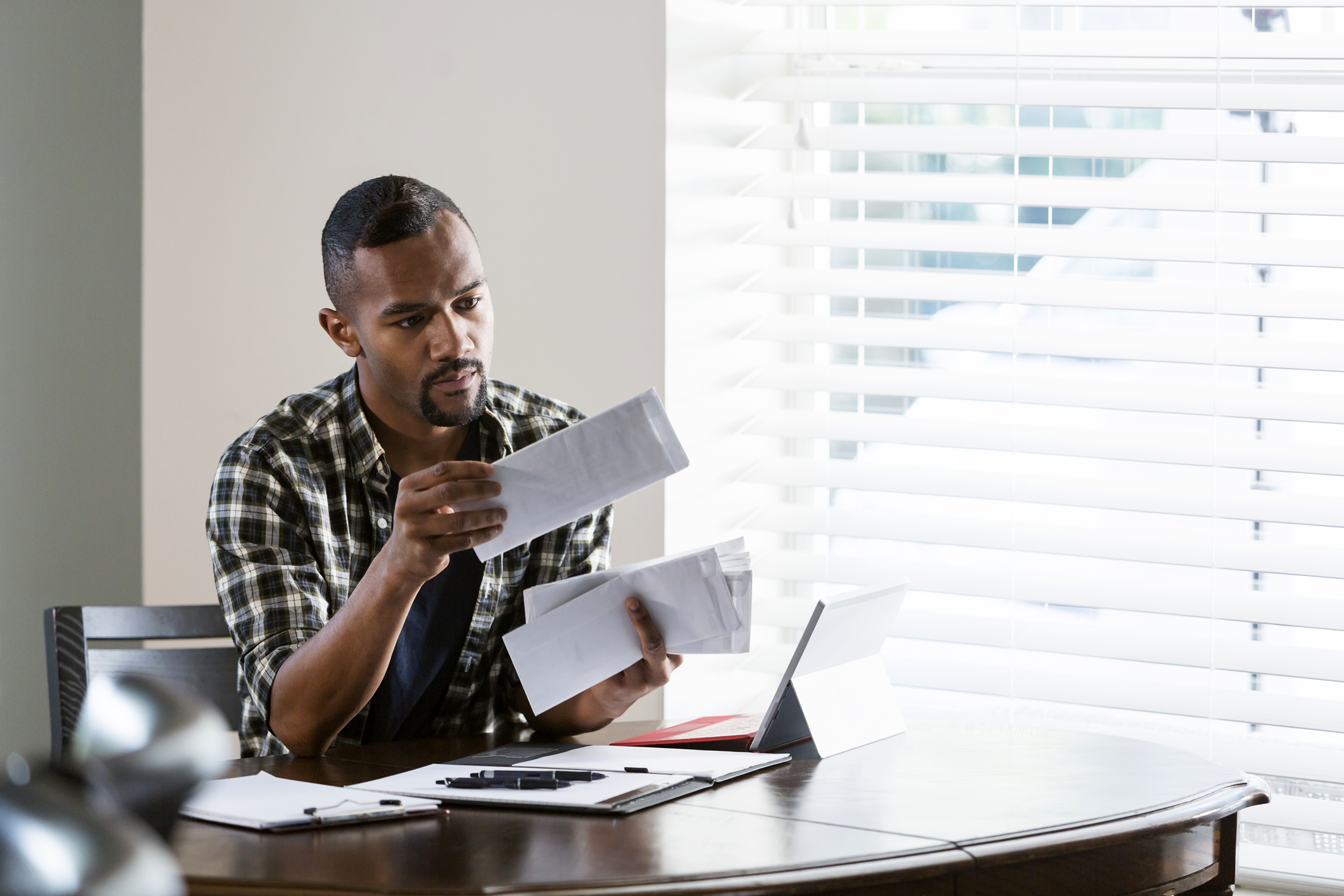 Man looking at bills