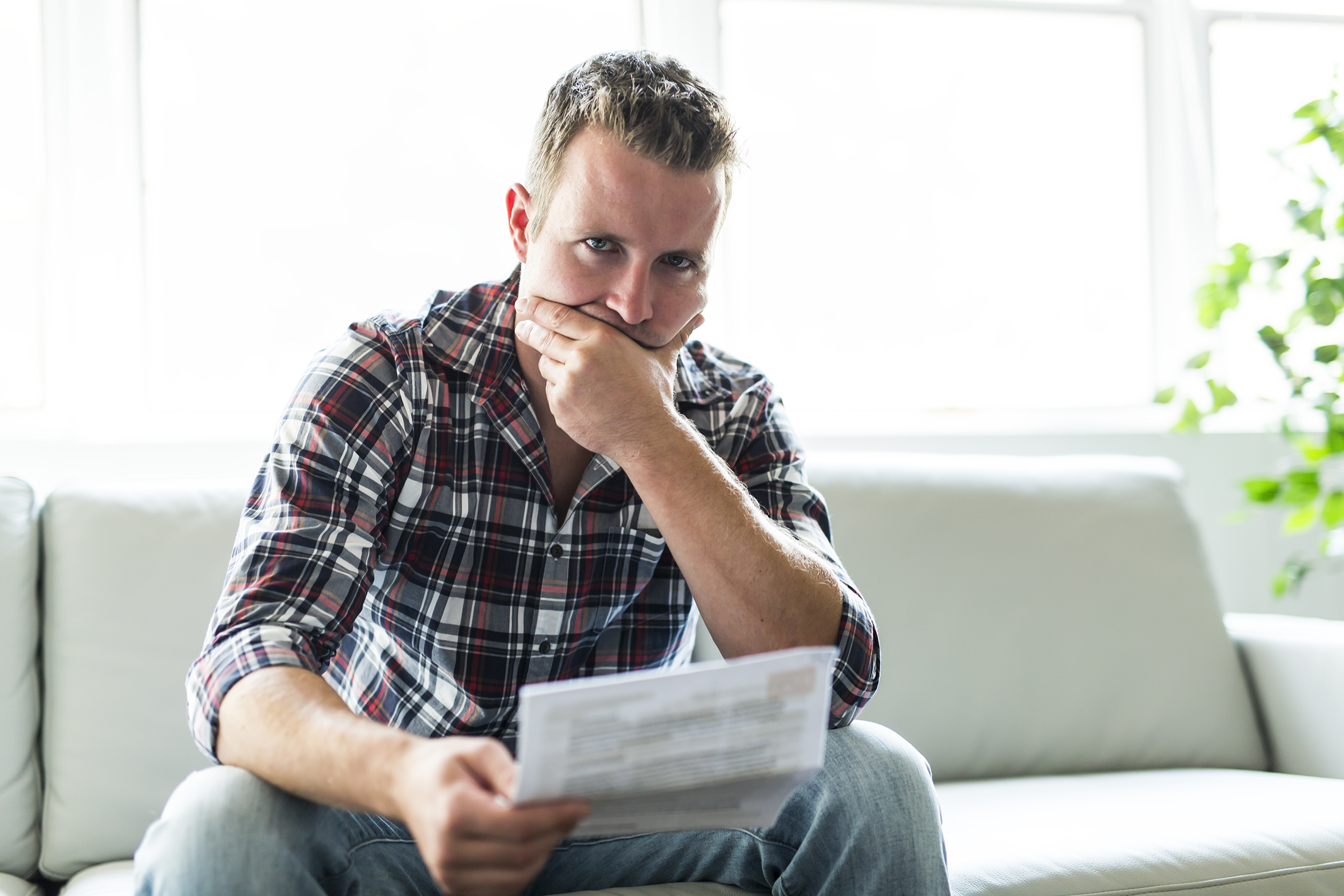Man looking disappointed at his bill