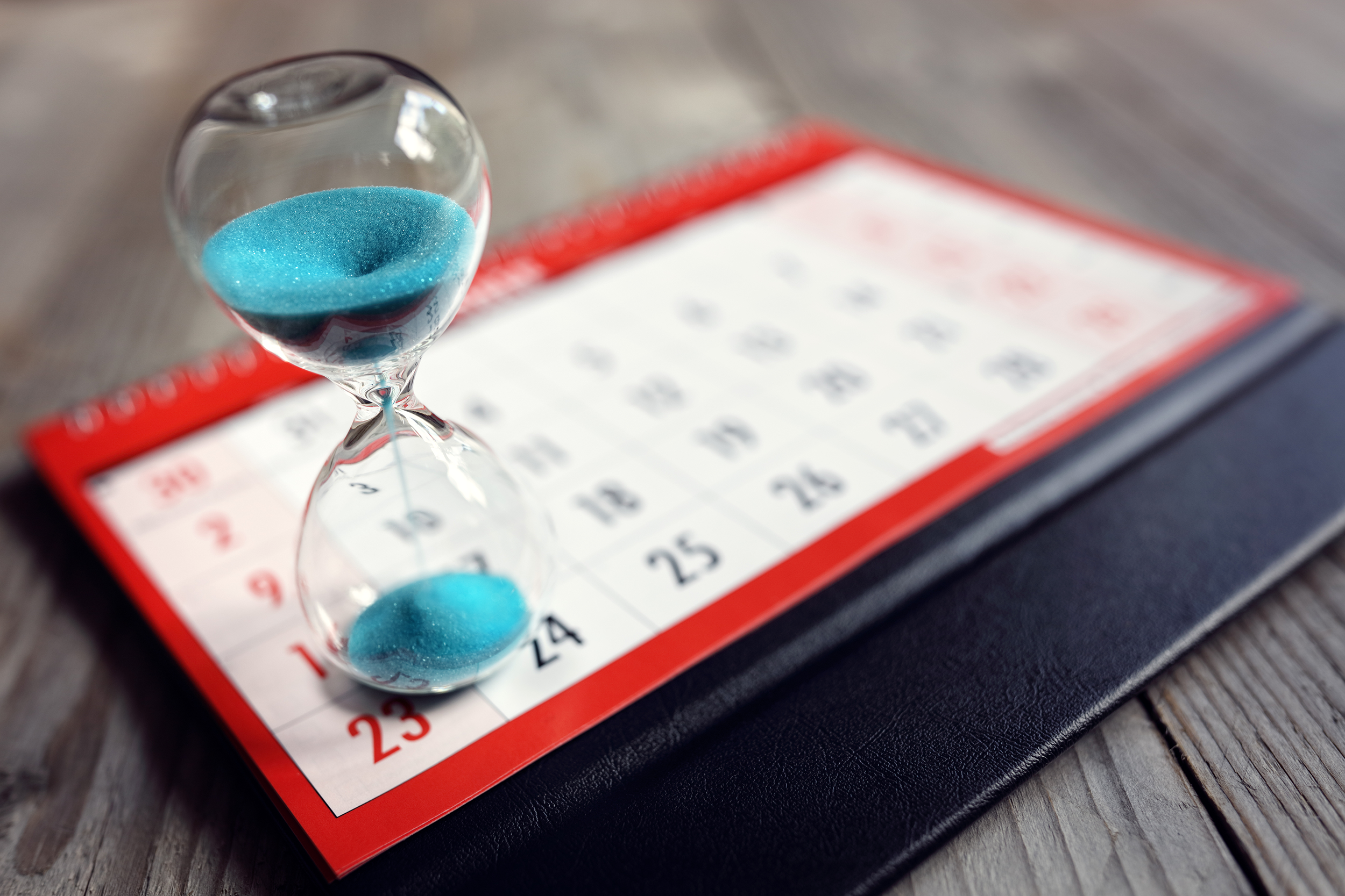 Hour glass next to a calendar with time running out