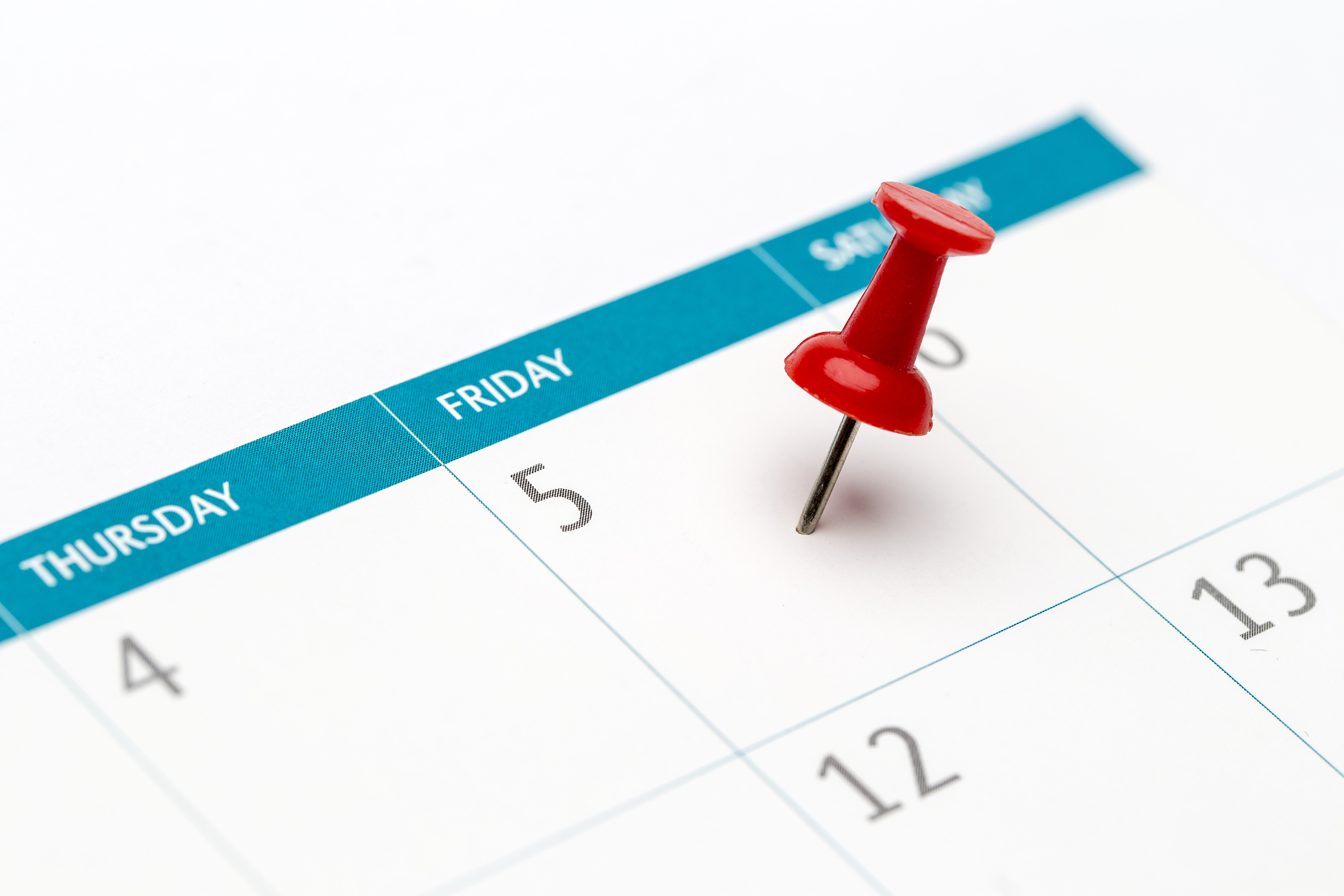 Calendar with a pin on Friday