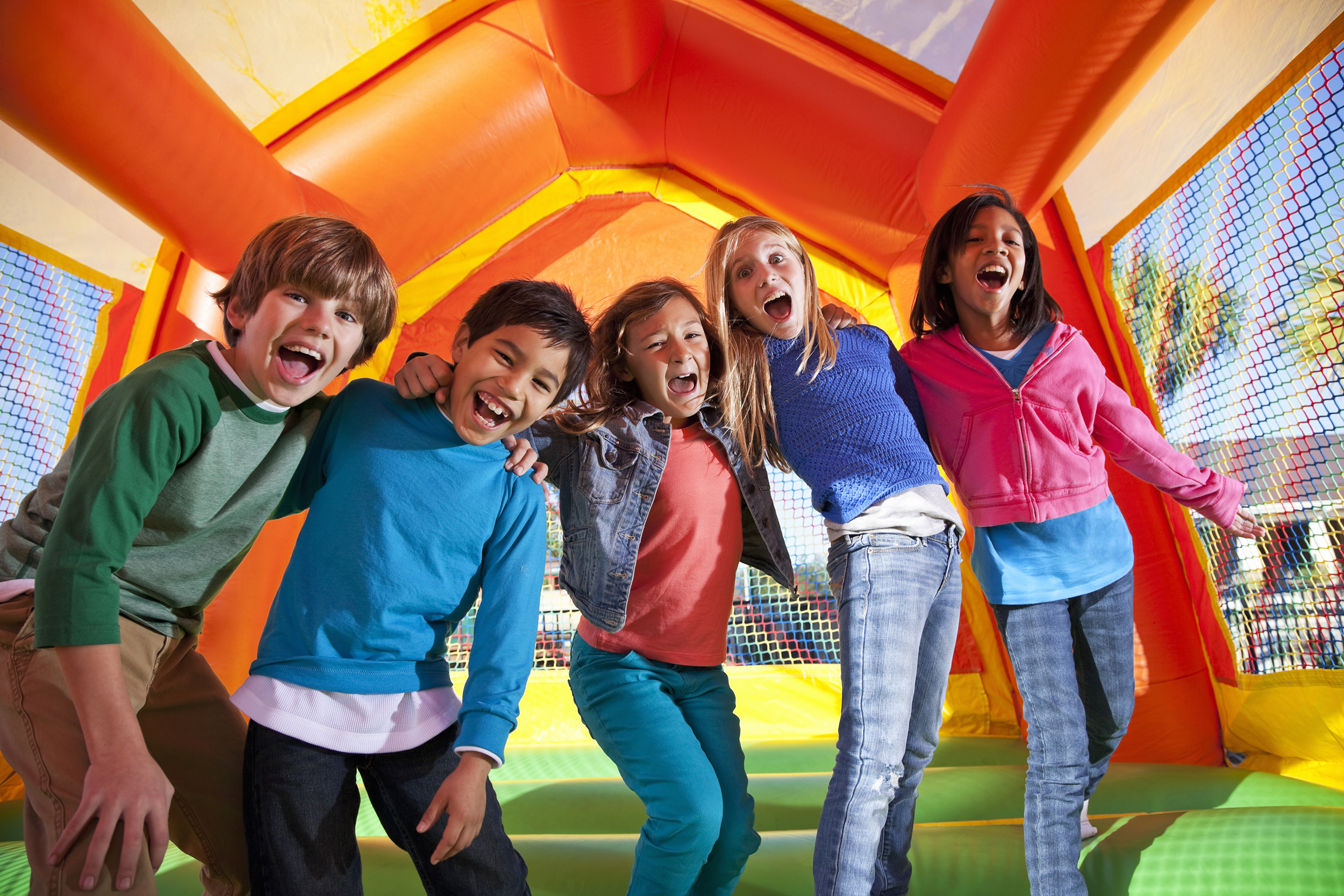 Kids jumping on an outdoor inflatable castle