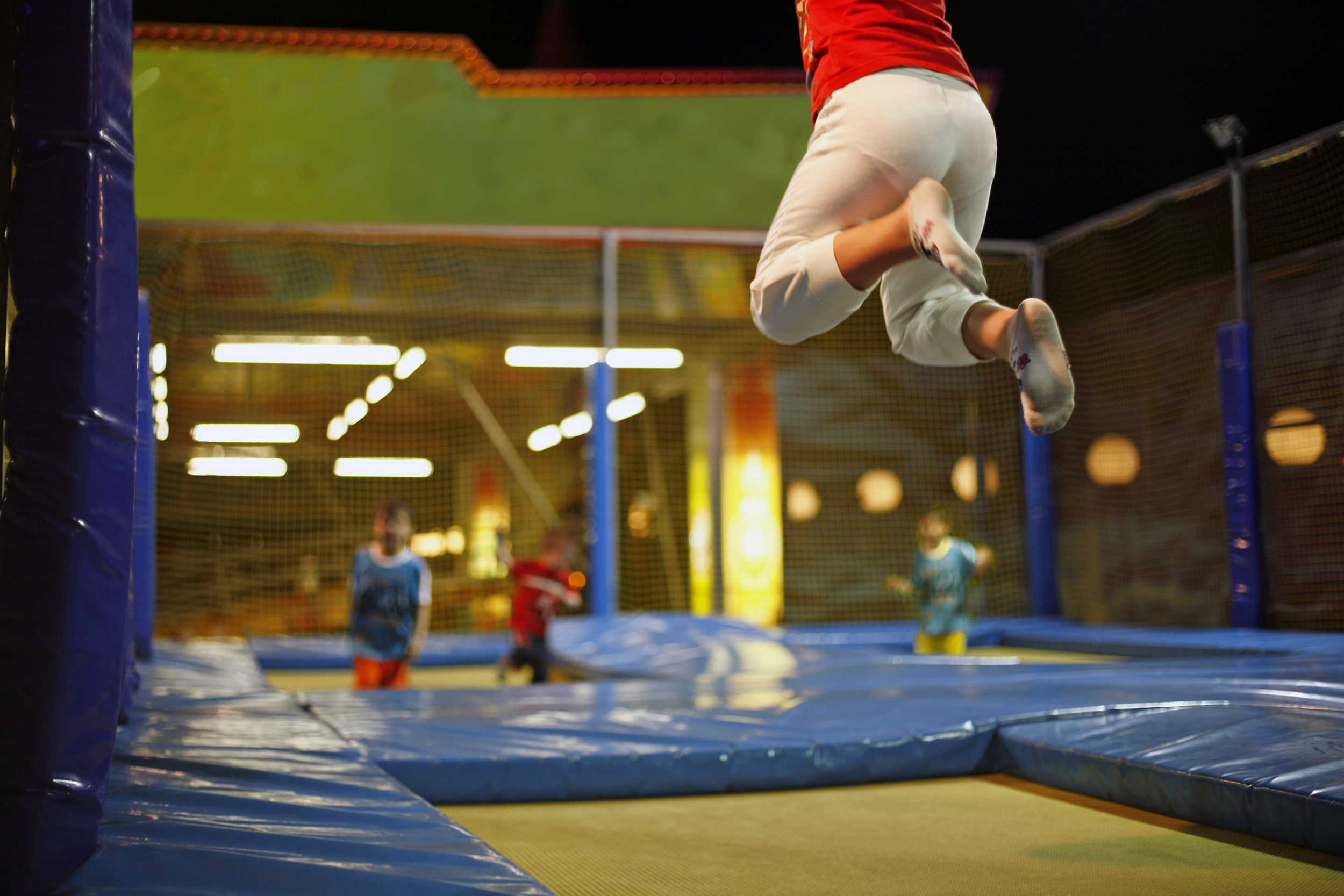 Kid jumping at an indoor trampoline park