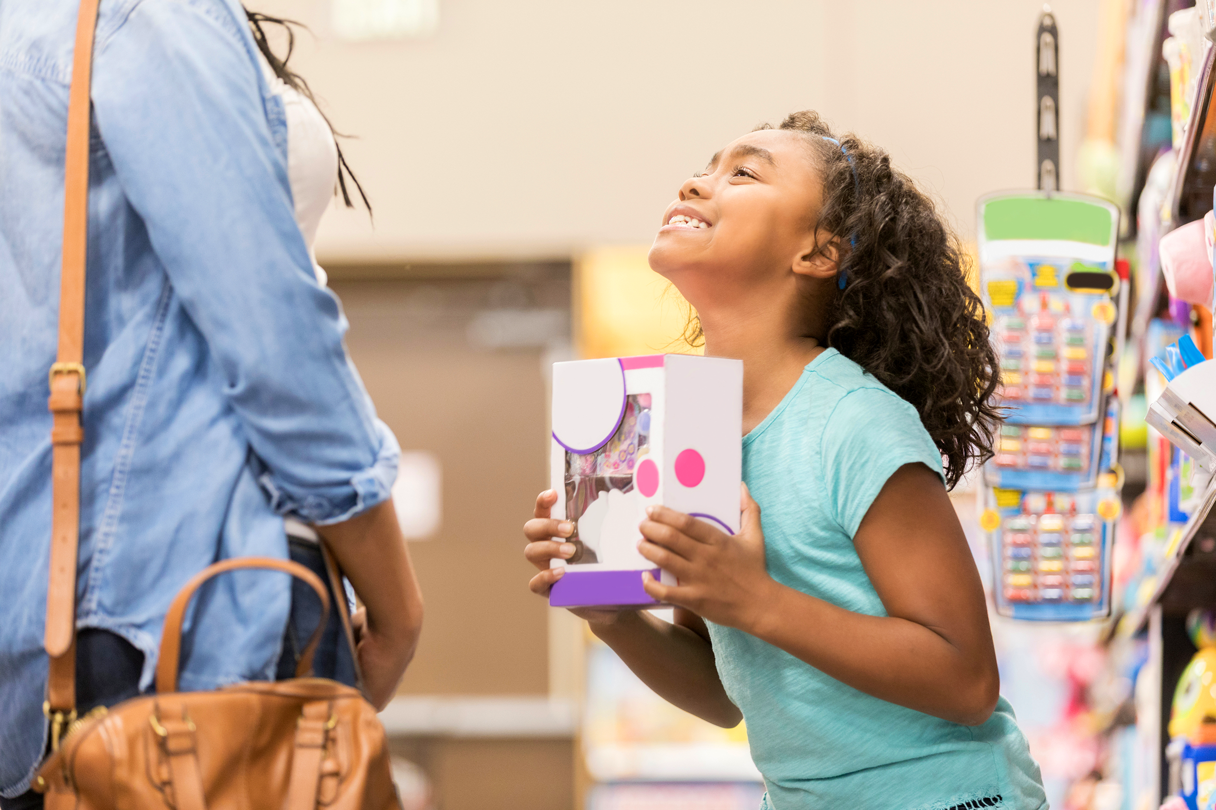 Little girl begging her mom to buy her a toy