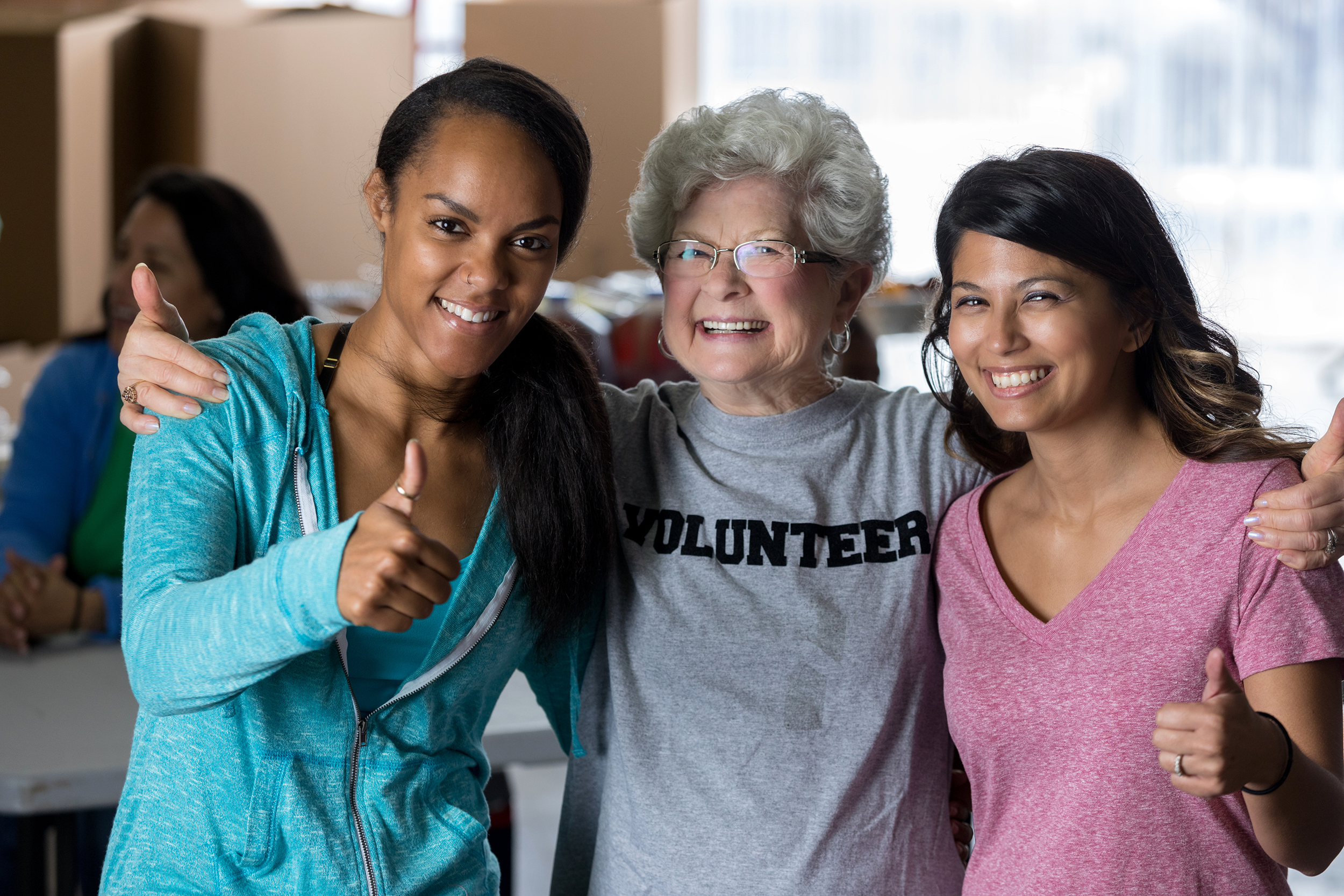 Senior woman volunteering with younger girls