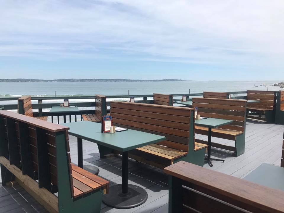 View of outdoor seating at Tides Restaurant in Nahant