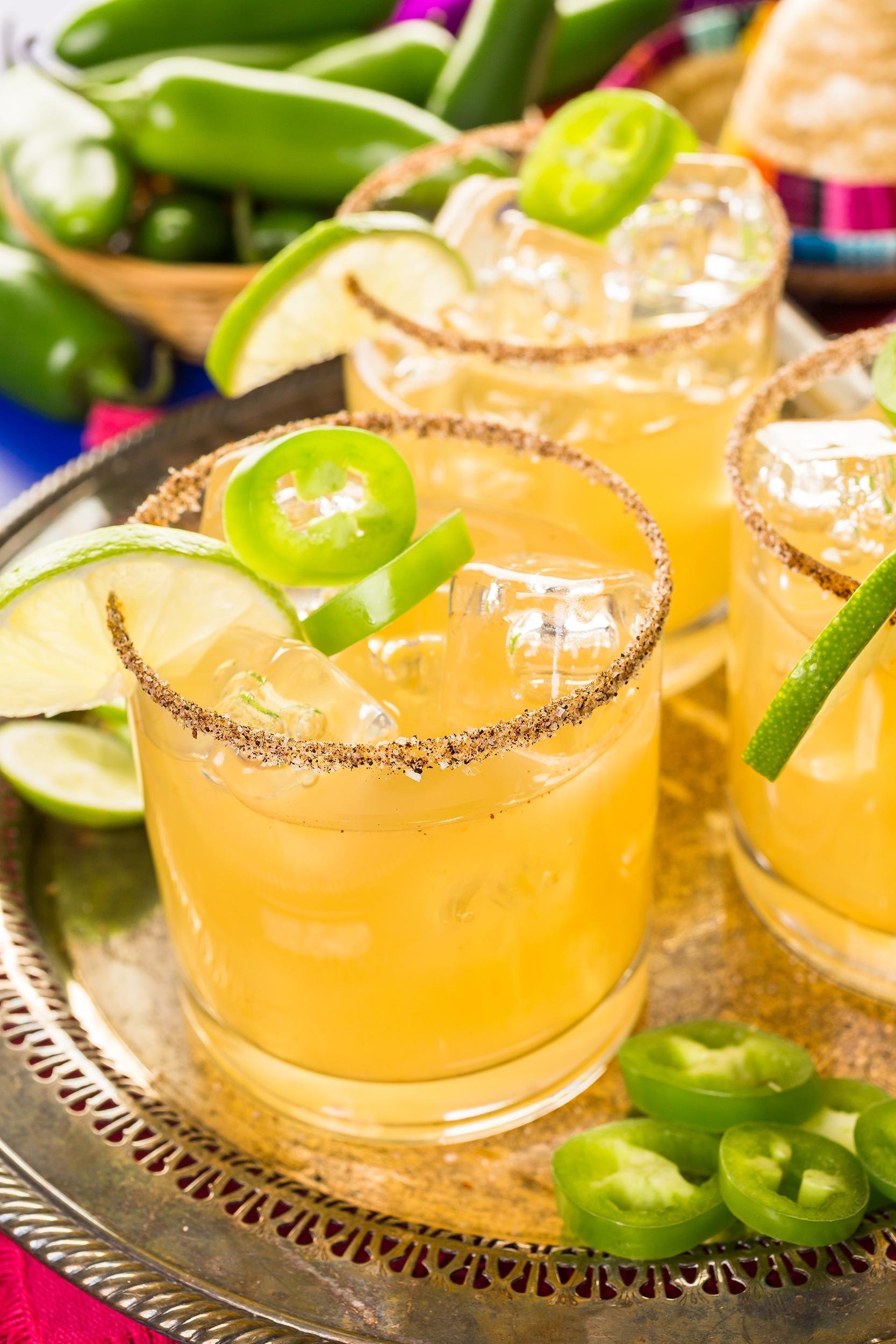 spicy grapefruit margarita cocktail garnished with lime and jalapeños