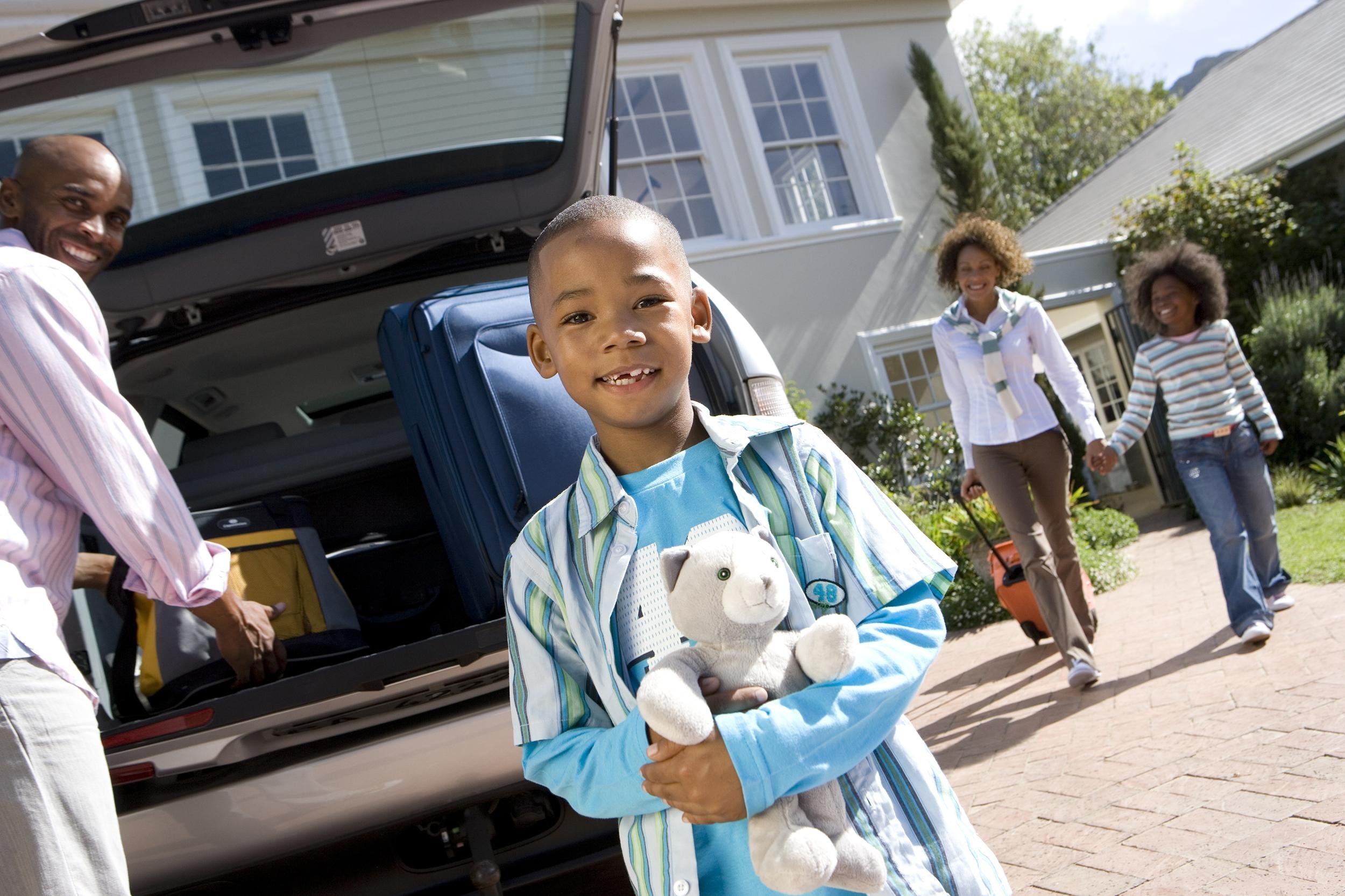 family leaving home for road trip