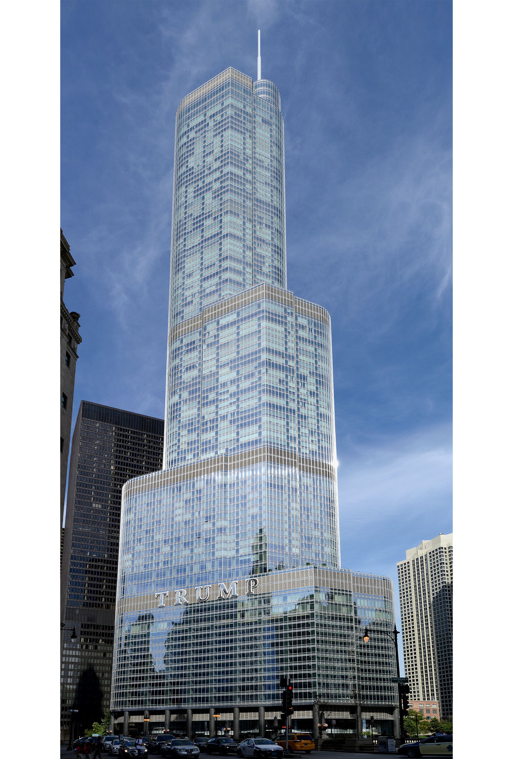 A tall silver skyscraper sits at a jog in the river beyond a bridge.