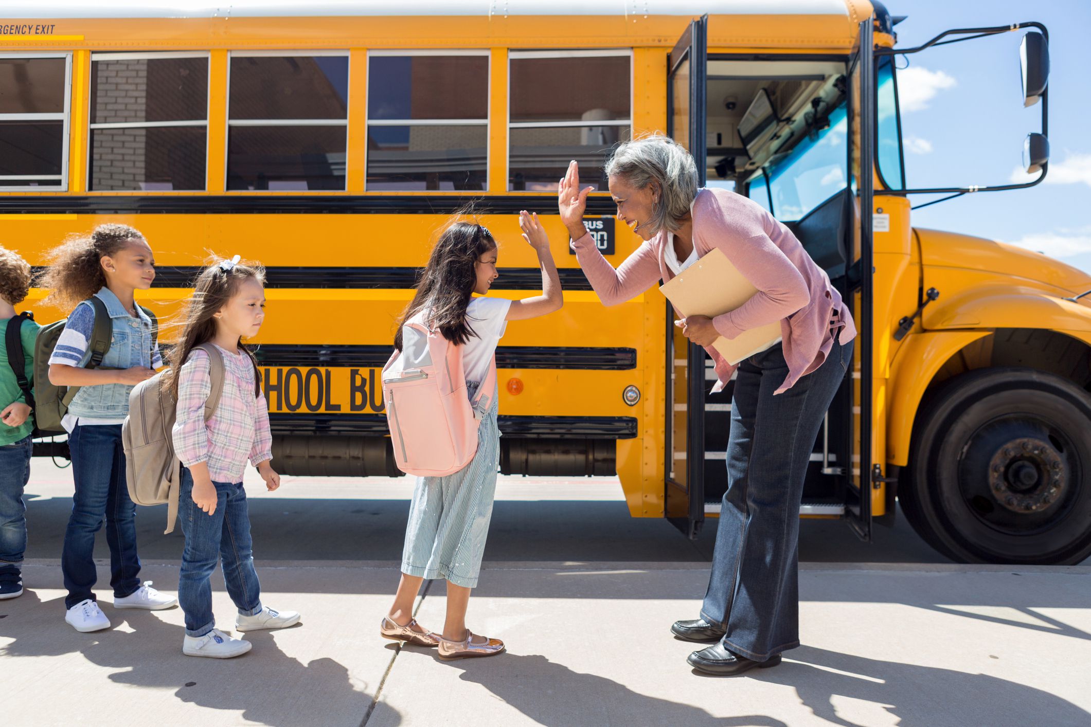 Child gives school bus driver a high-five