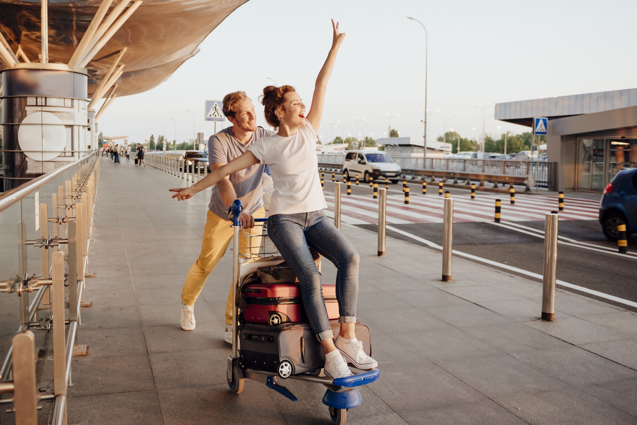 Loving couple, at airport, having fun before going on trip