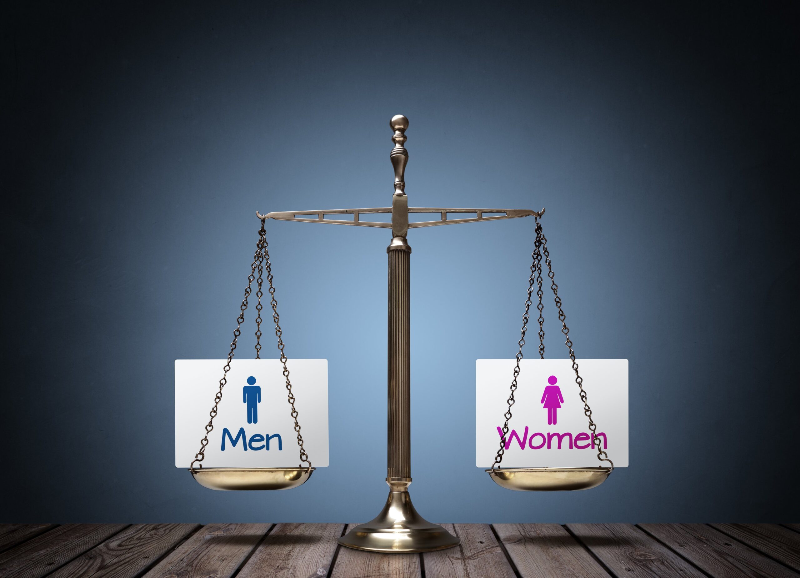 balanced scale with men on one side and women on the other