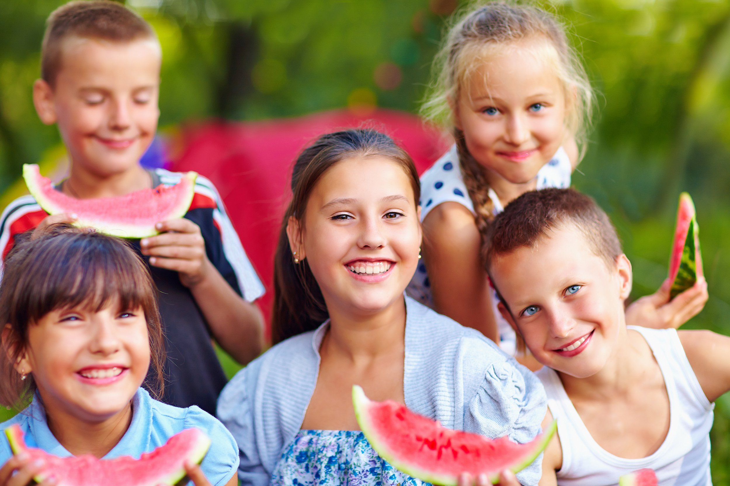 happy kids eating watermelon