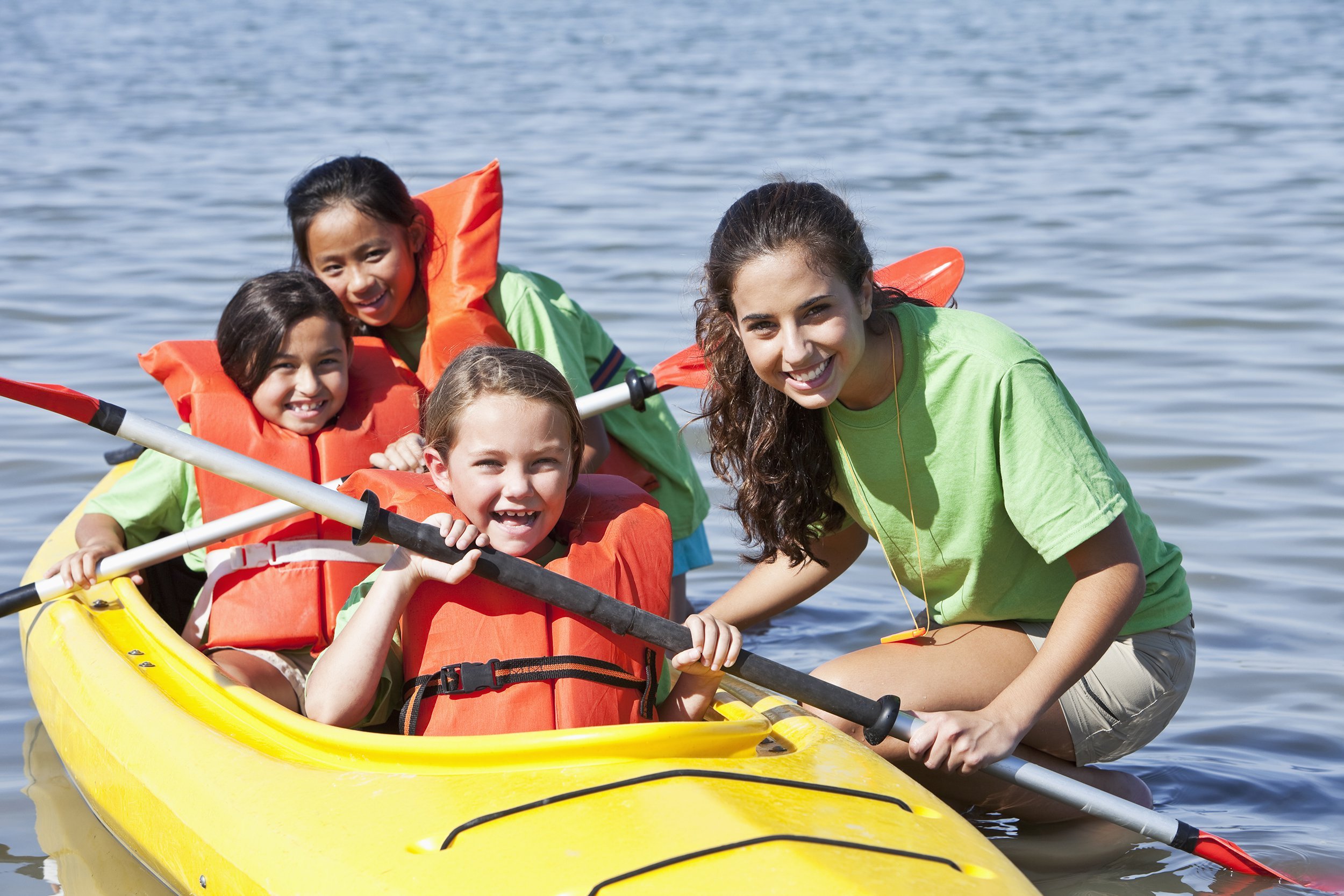 girls in a double kayak at summer camp